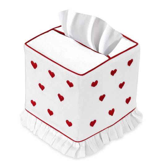 White tissue box cover with red heart patterns and ruffled edge on a white background