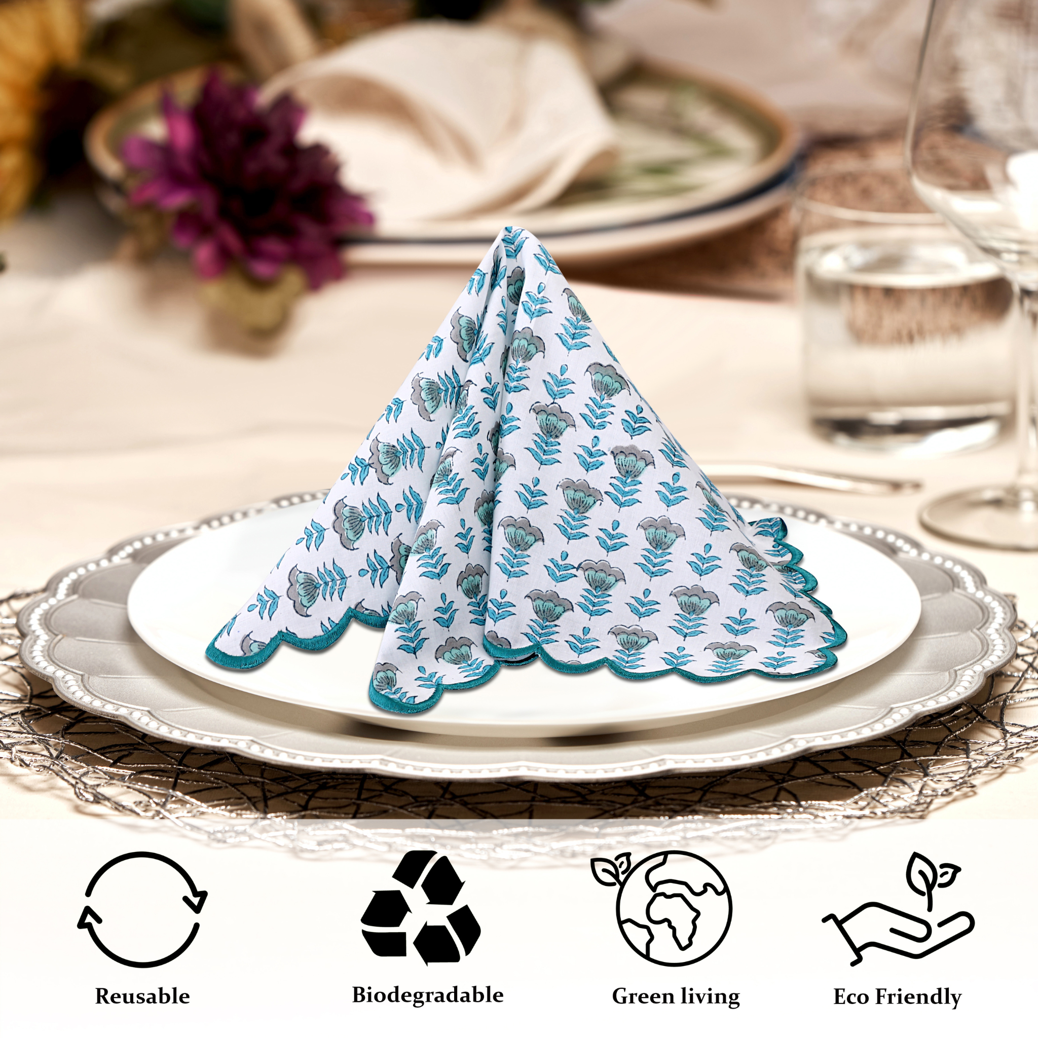 Napkin folded into a decorative shape on a table setting with eco-friendly icons below.