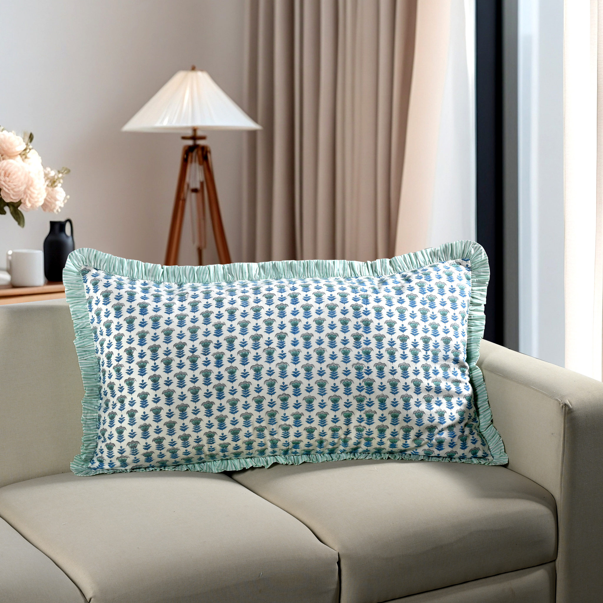 Blue floral block print cotton pillow styled on a beige sofa in living room.