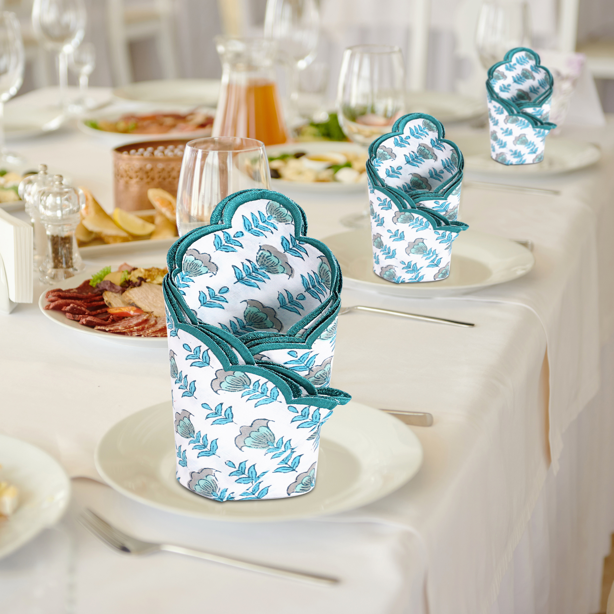 Patterned containers on a table with a dining setup in the background