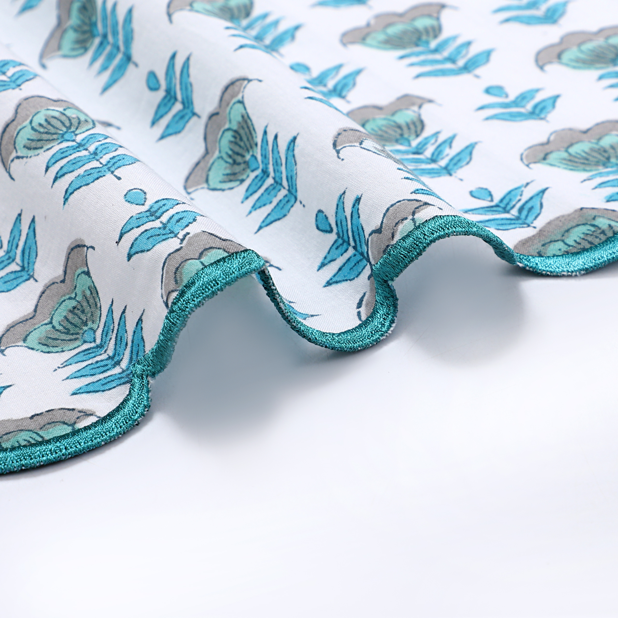 Fabric with blue and gray leaf pattern on a white background