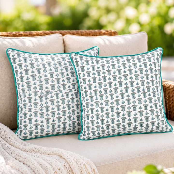 Pair of patterned pillows on a sofa with a neutral background