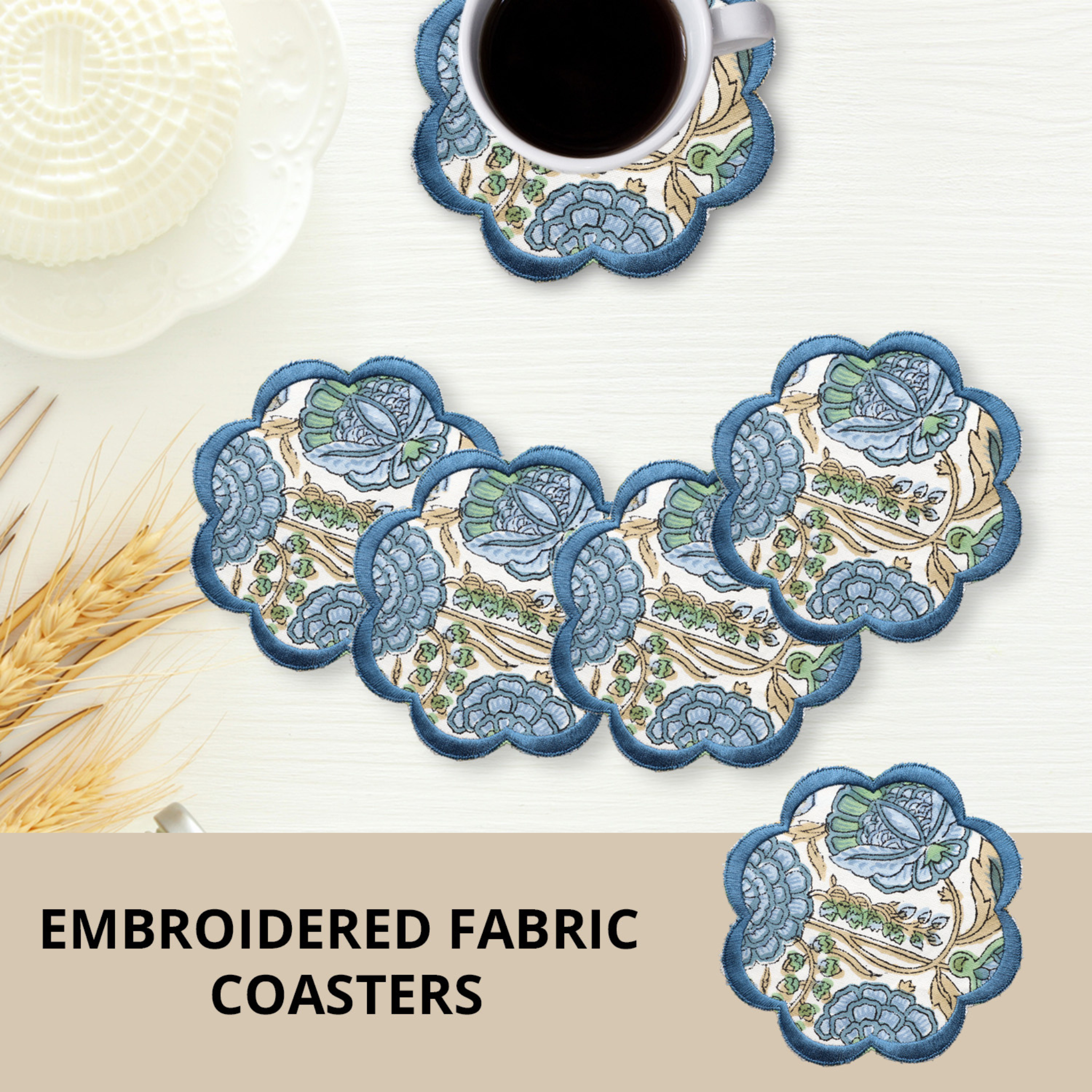Set of embroidered fabric coasters with a cup of coffee on a white surface.