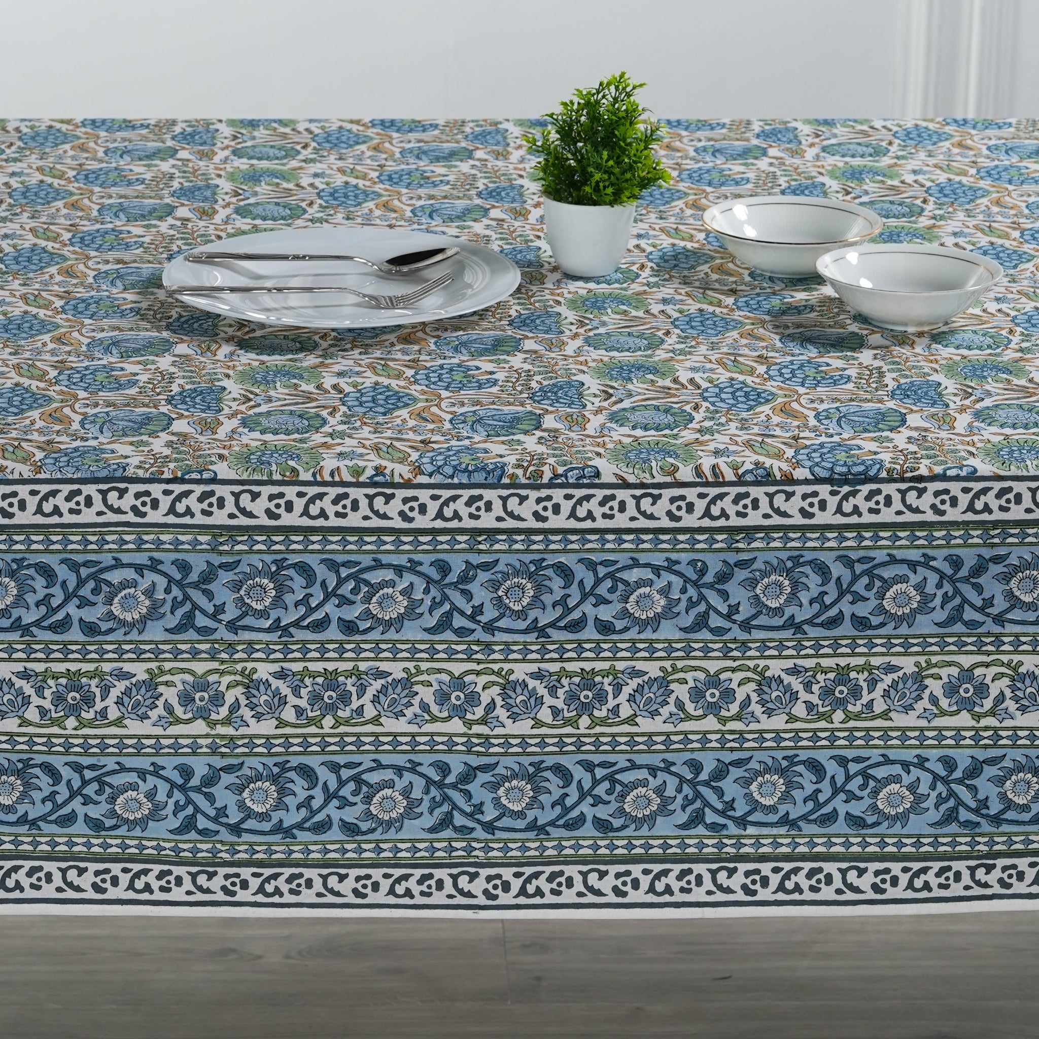 Decorative tablecloth with floral pattern on a wooden table