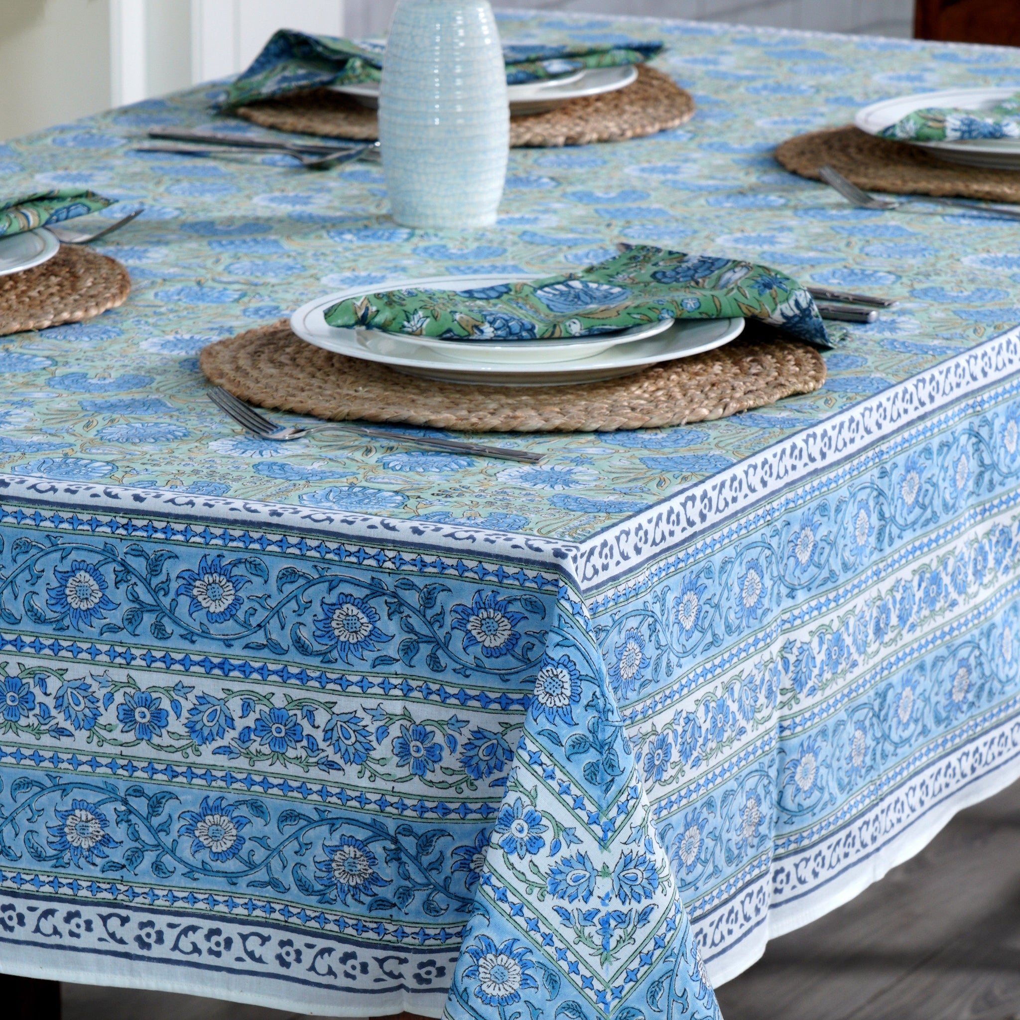 Tablecloth with blue floral pattern on a wooden table