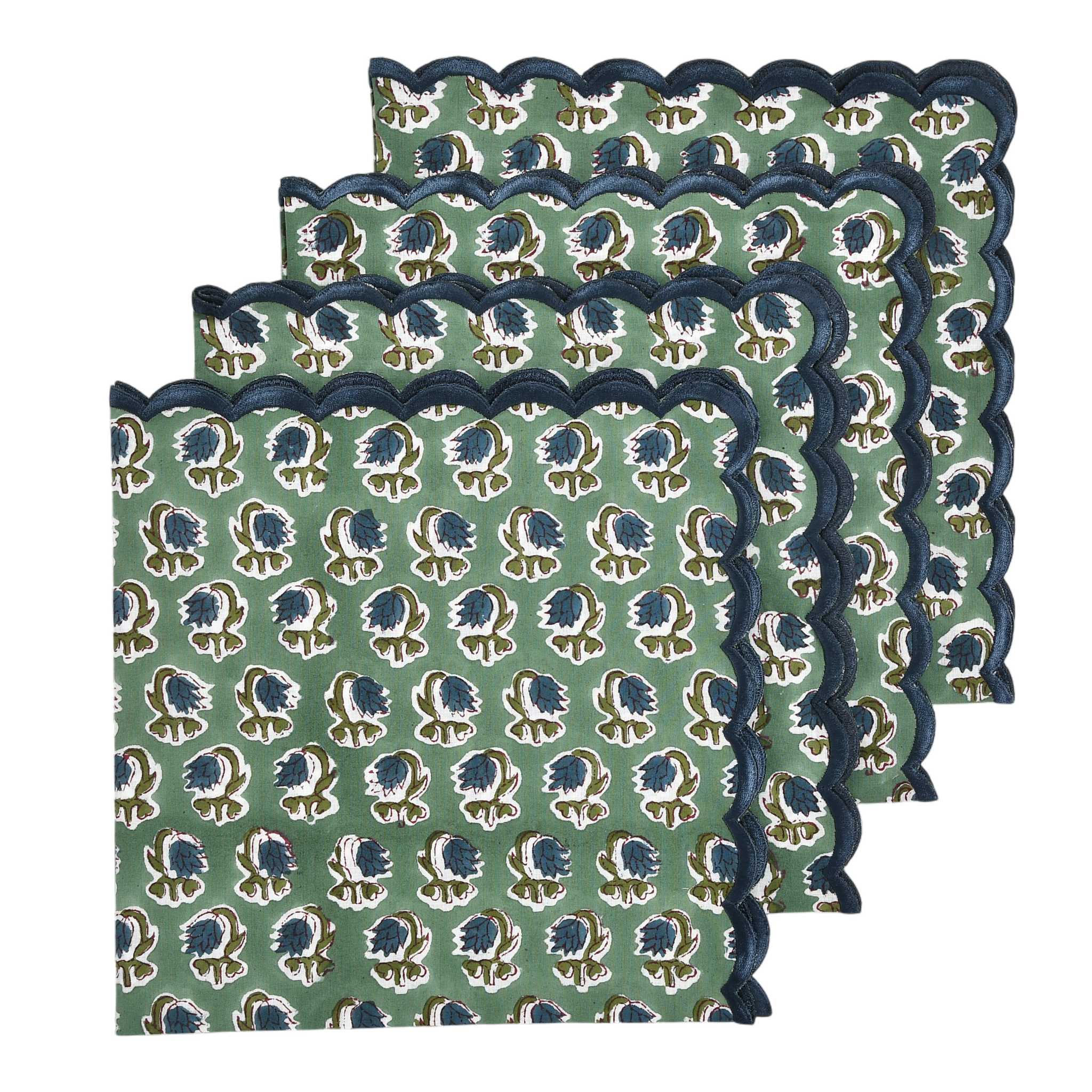 Set of three green placemats with blue floral pattern and scalloped edge on a white background