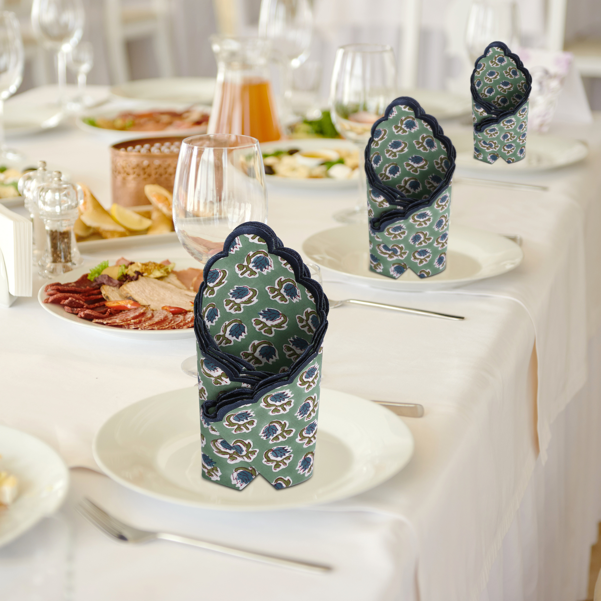 Decorative folded napkins on a table setting with plates and glasses.