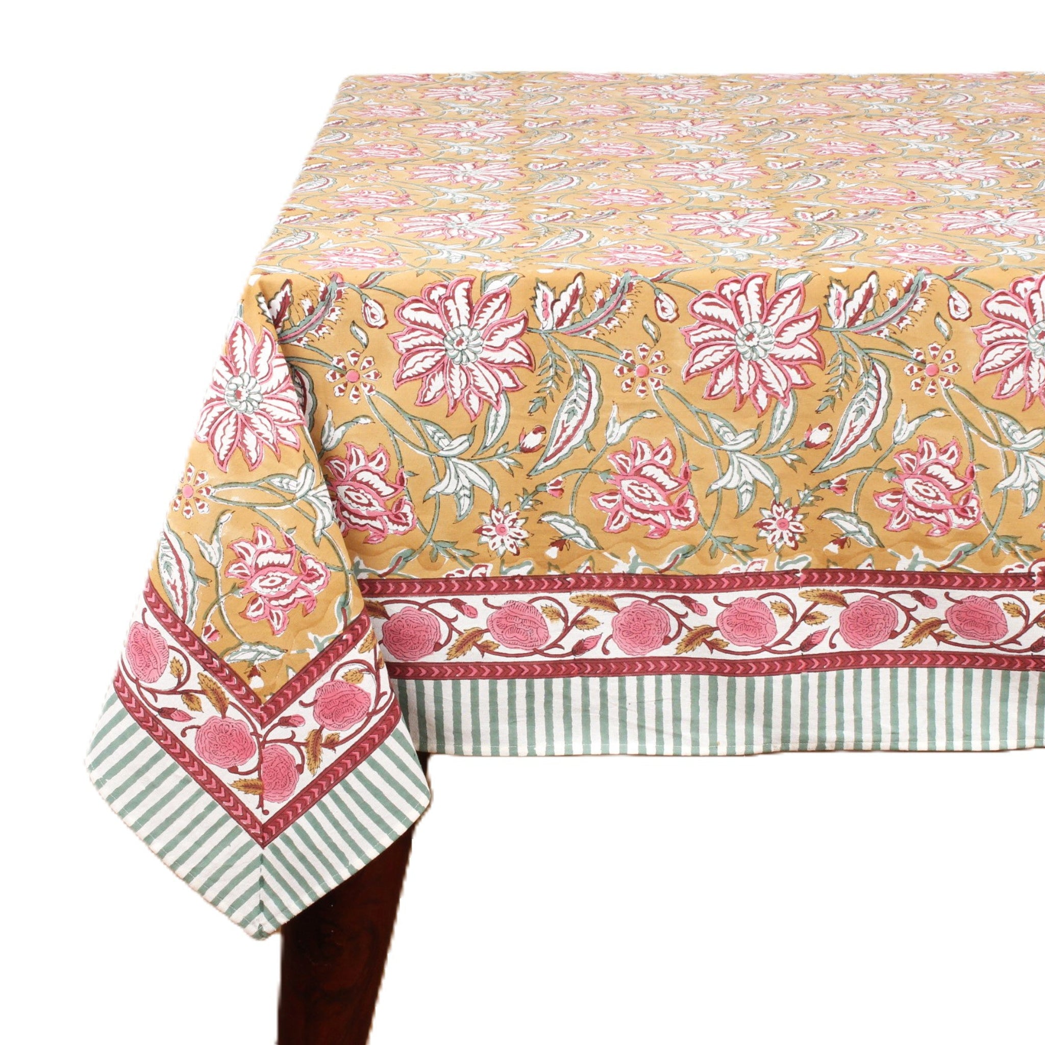 Floral patterned tablecloth with pink flowers on a yellow background