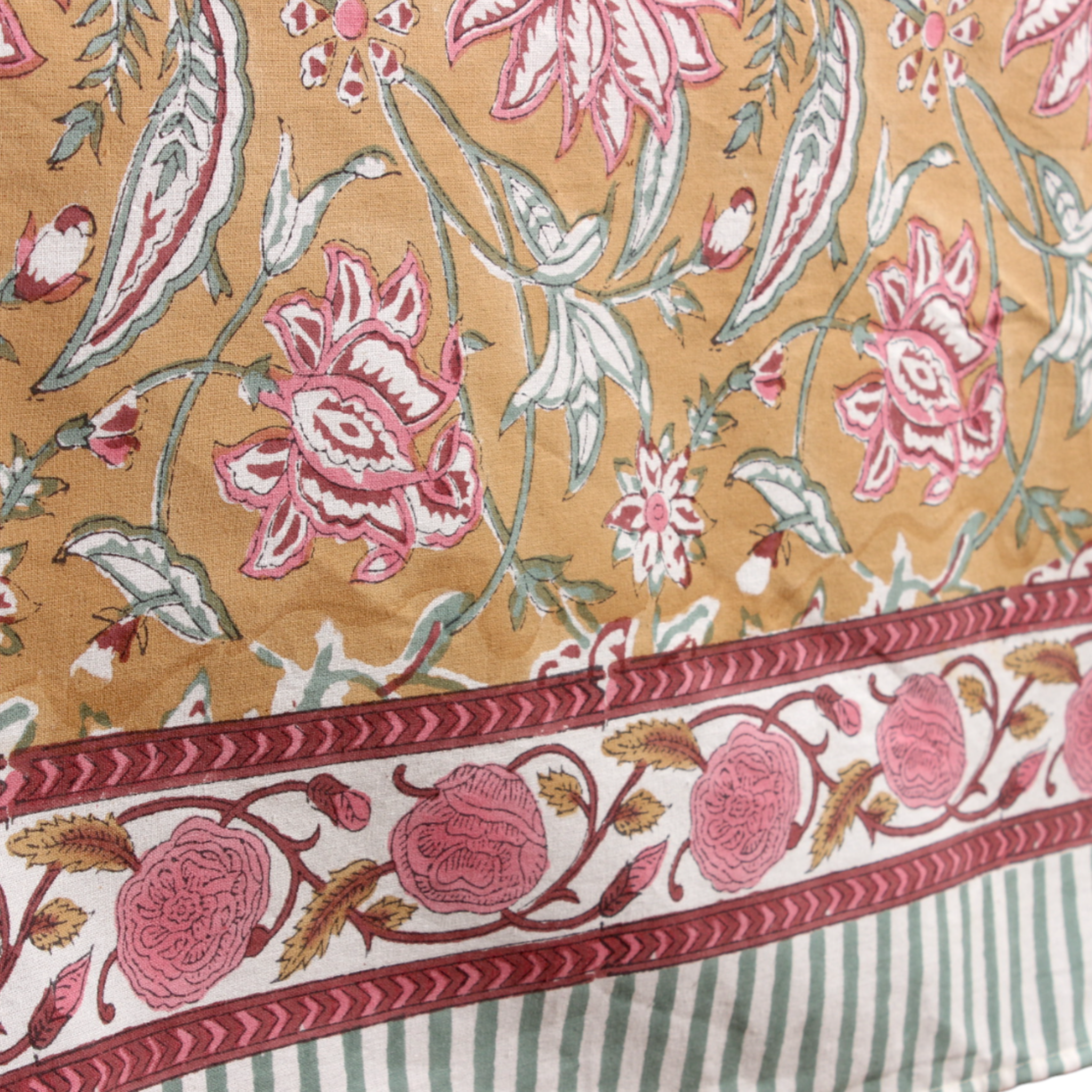 Floral patterned fabric with pink and white flowers on a beige background