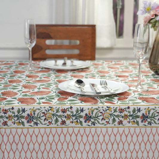 Table setting with a floral-patterned tablecloth on a dining table.