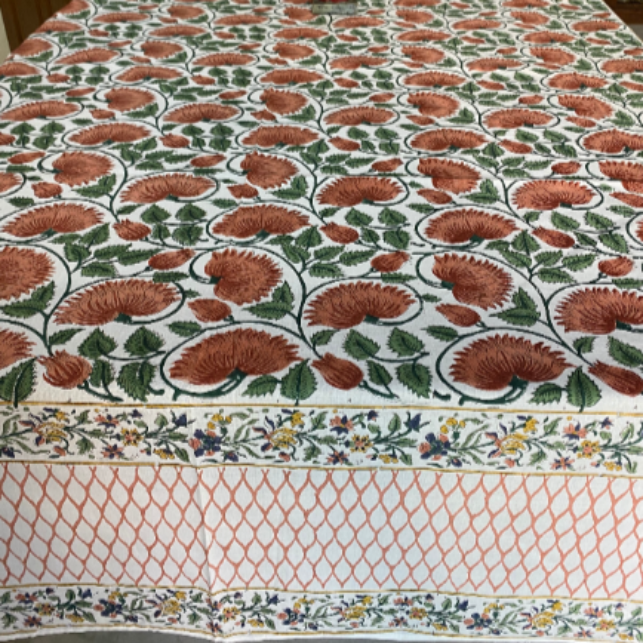 Floral patterned tablecloth on a table with a blurred background