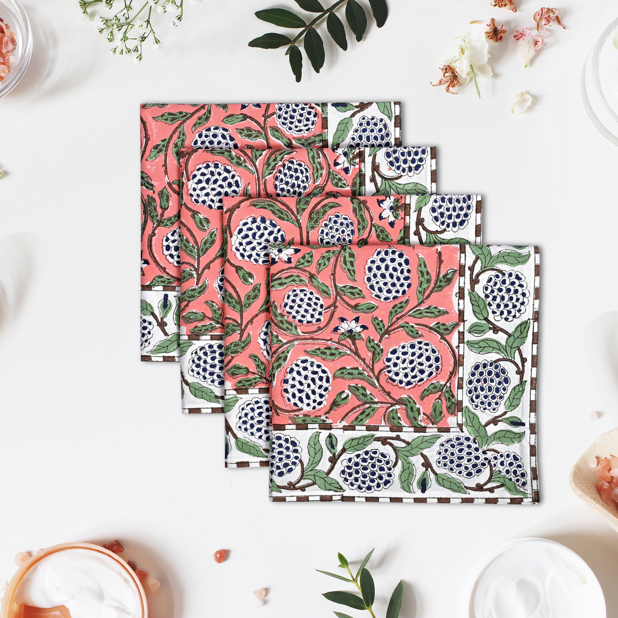 Set of three floral-patterned placemats on a white surface with decorative elements.