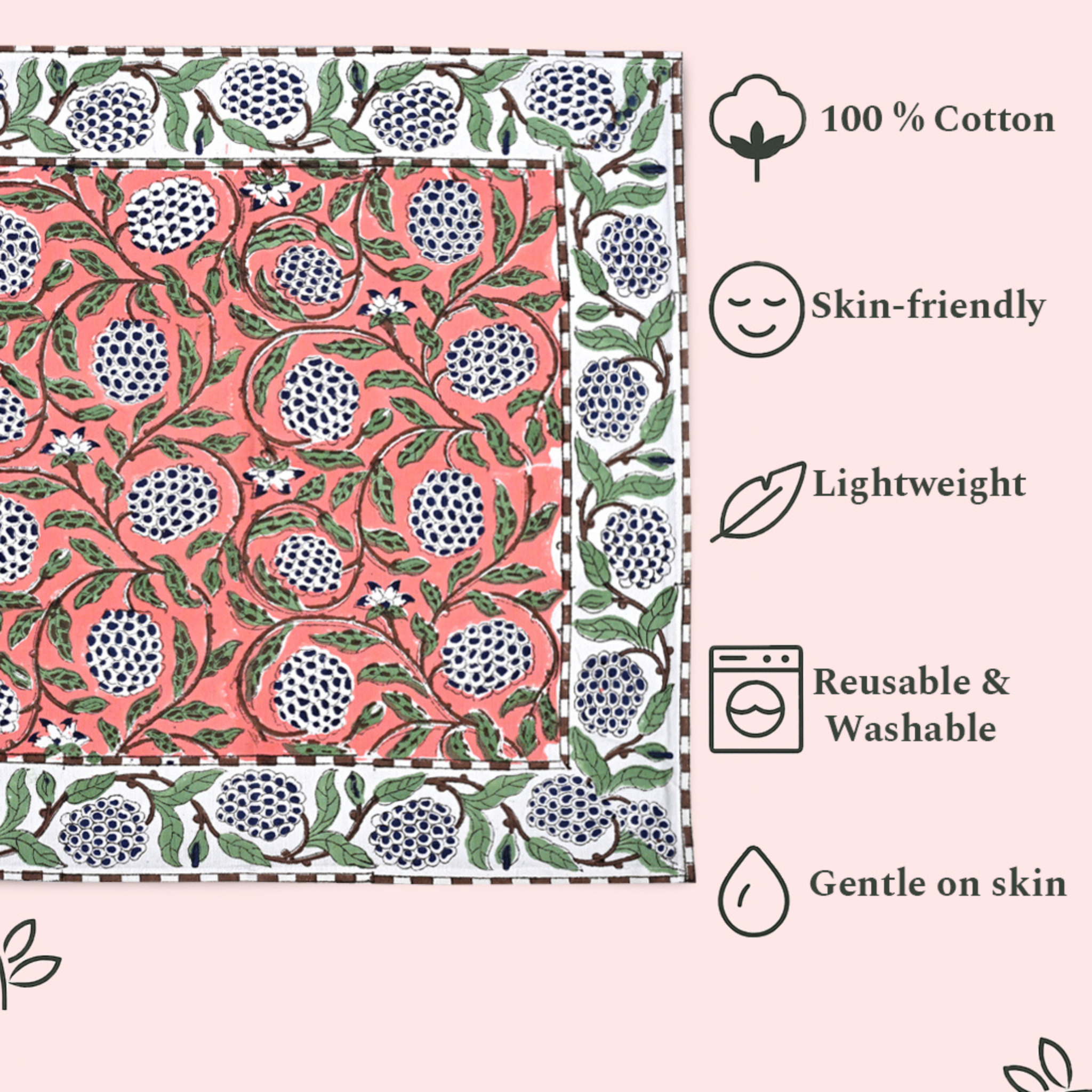 Patterned fabric with pomegranate design and text highlighting features like 100% cotton, skin-friendly, lightweight, reusable, washable, and gentle on skin.