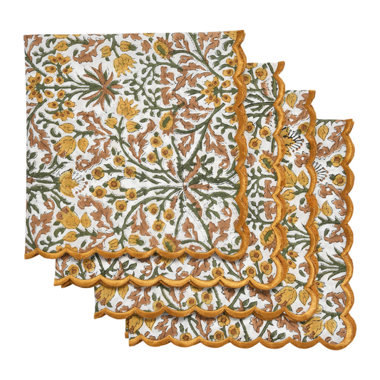 Set of floral patterned placemats with scalloped edge on a white background