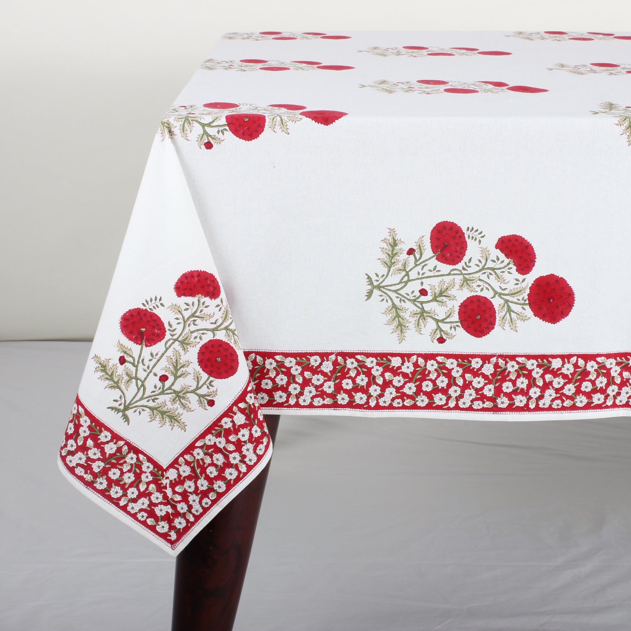 Decorative tablecloth with floral and berry pattern on a white background