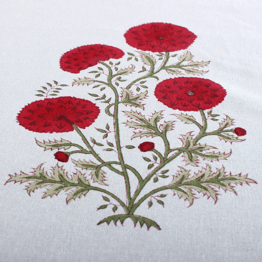 Embroidered design of red flowers on a white fabric background