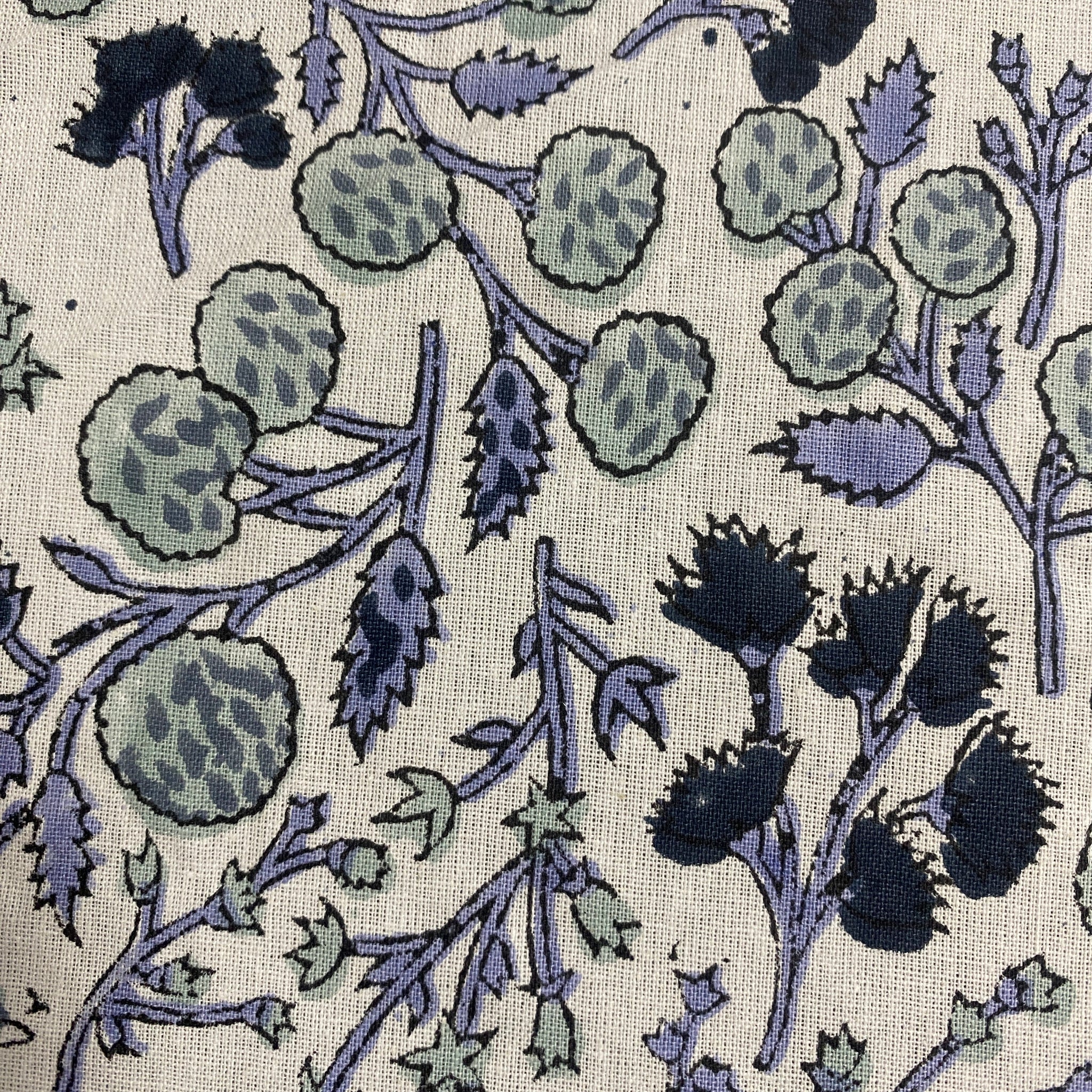 Floral pattern with blue and green colors on a textured fabric background