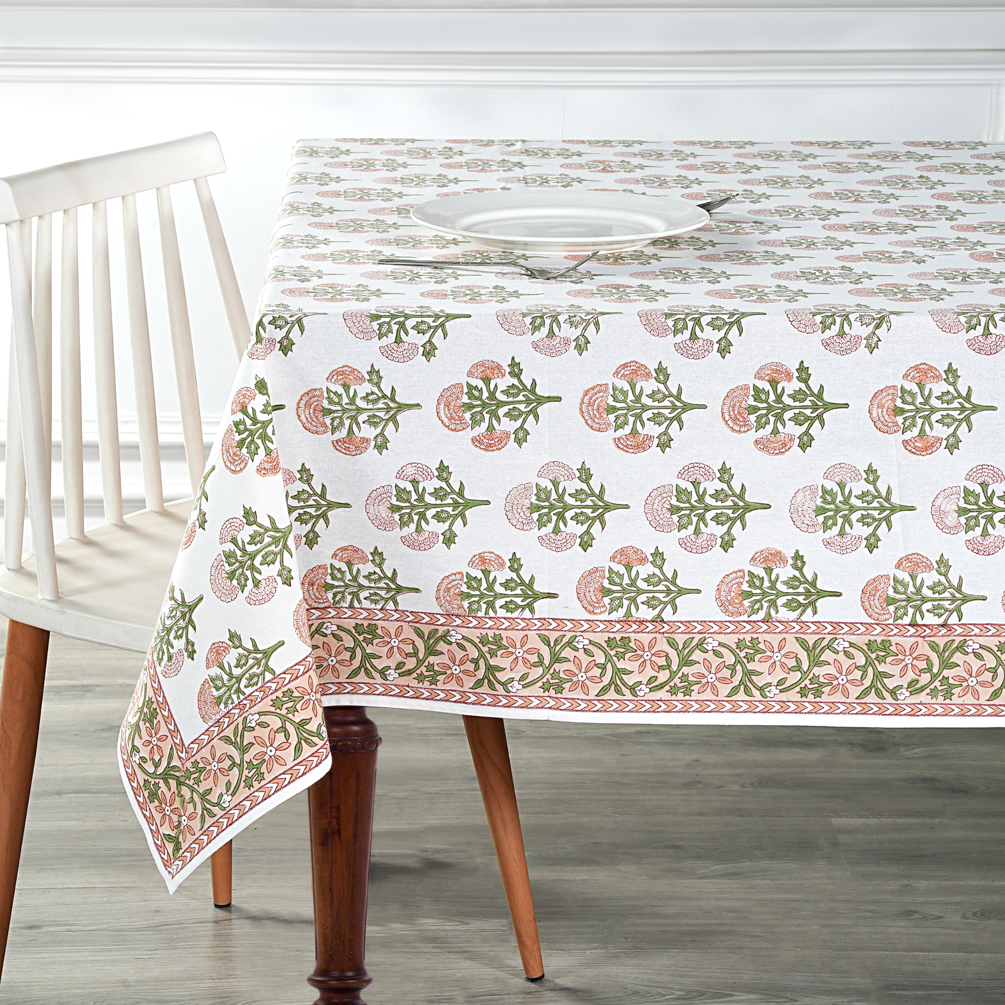 Tablecloth with floral pattern on a wooden table and chair