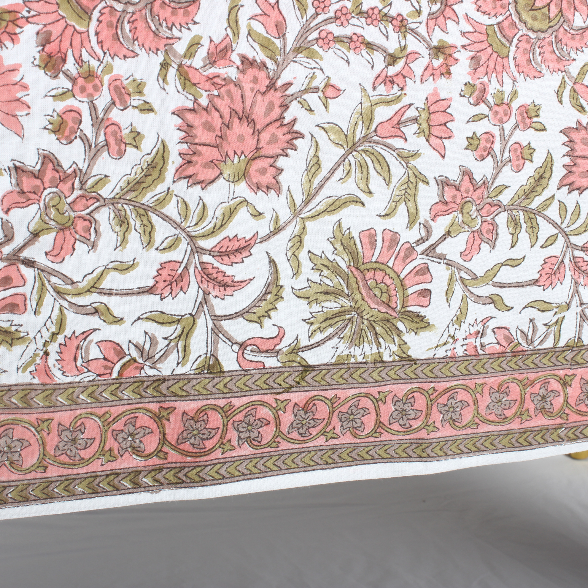 Floral patterned fabric with pink and green flowers on a white background