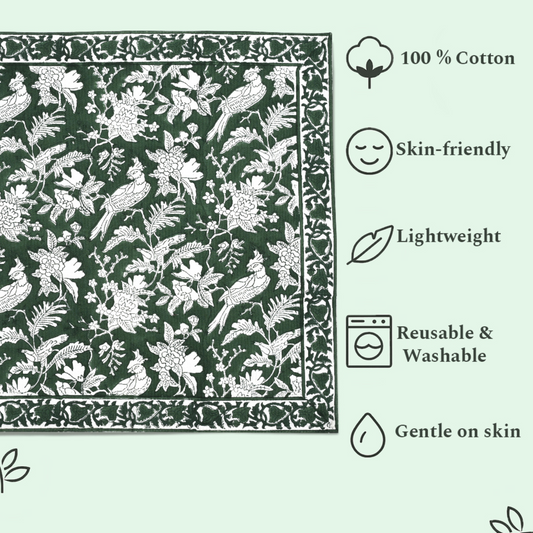 Green fabric with white floral and bird pattern, featuring icons and text about fabric properties.