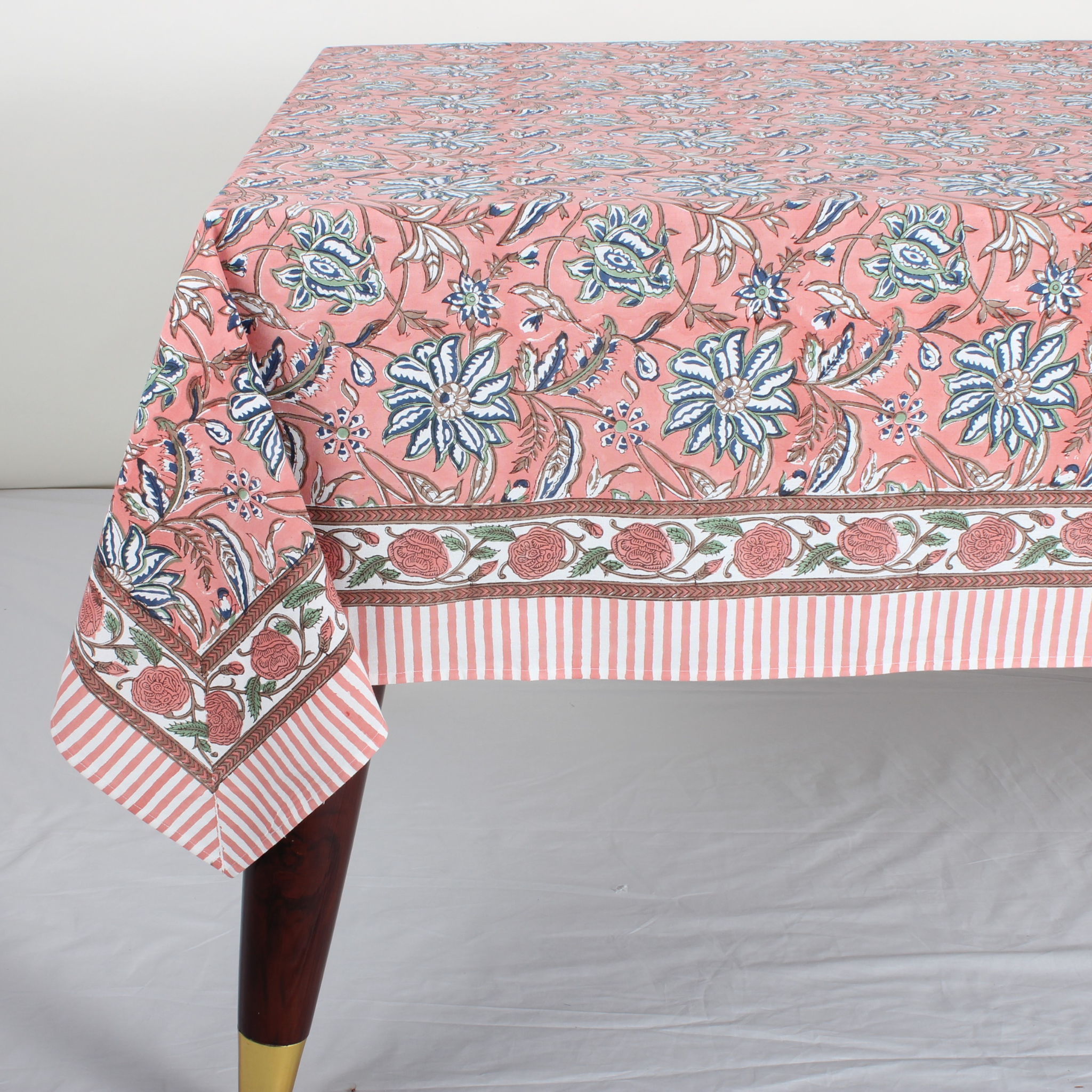 Tablecloth with floral and striped pattern on a plain background