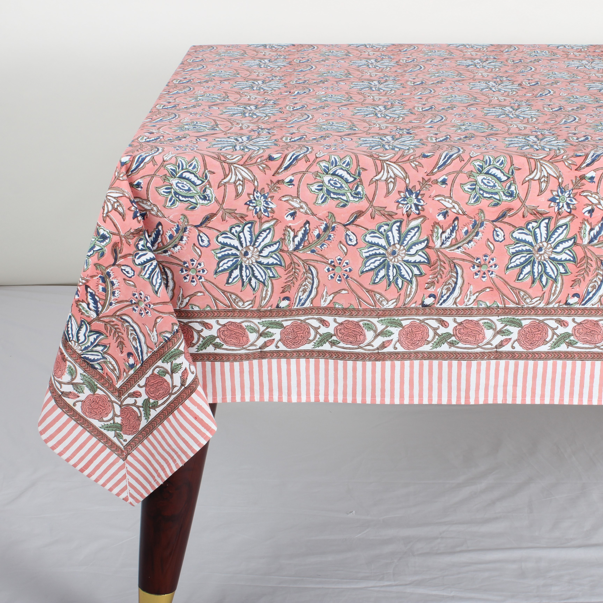 Floral patterned tablecloth on a table with a white background