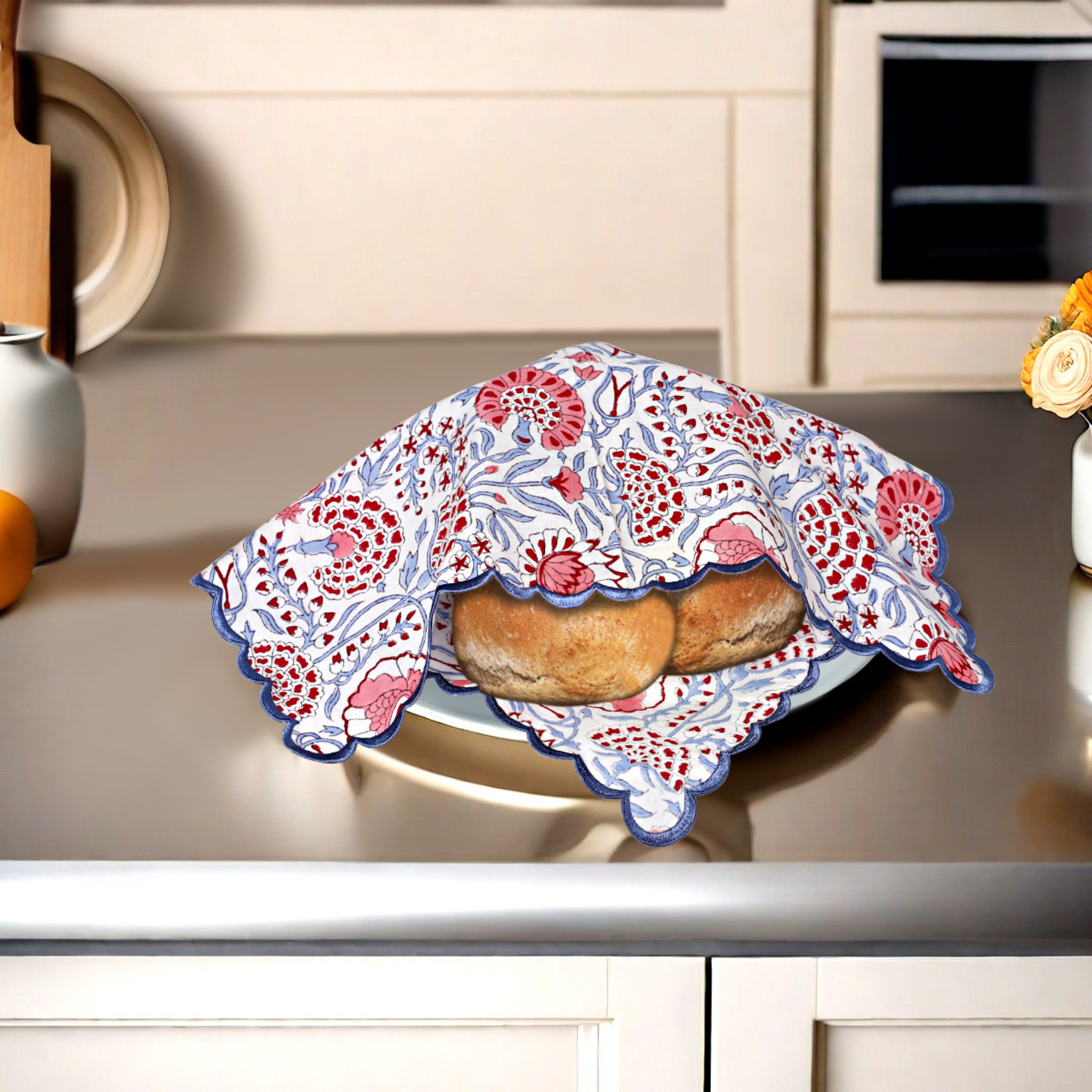 Bread wrapped in a decorative cloth on a kitchen counter