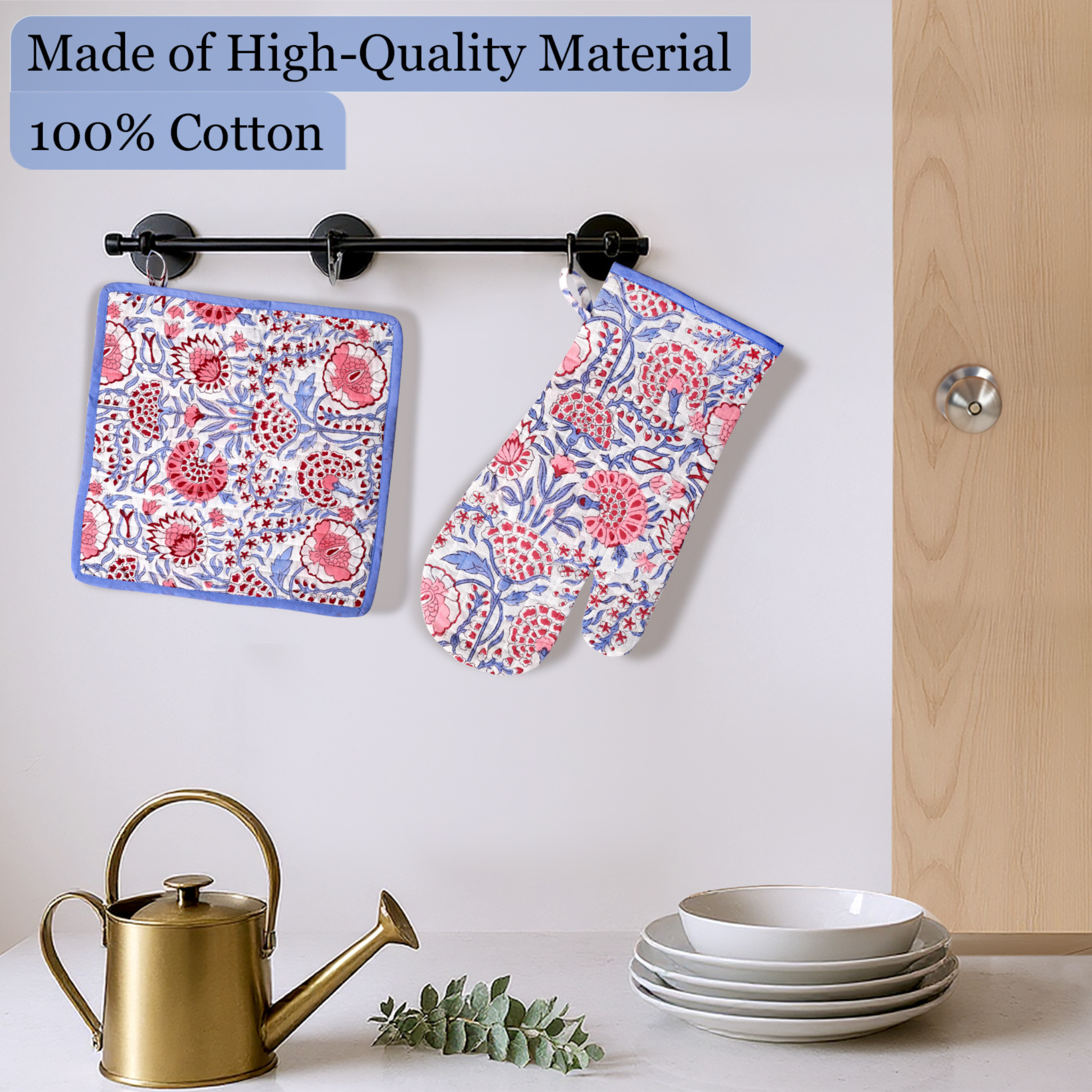 Floral-patterned pot holder and towel hanging on a rack with kitchen items below.