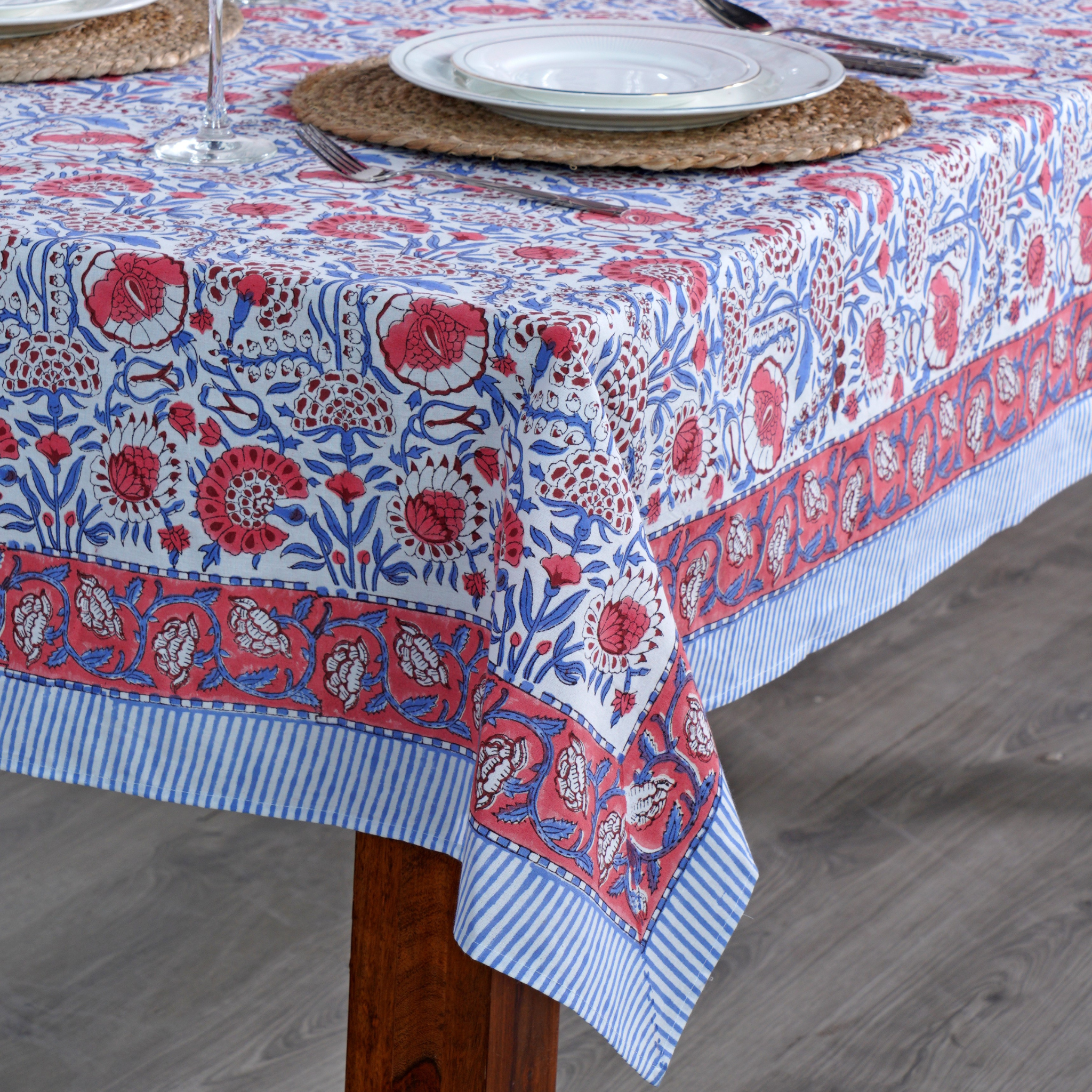 Tablecloth with red and blue floral pattern on a wooden table