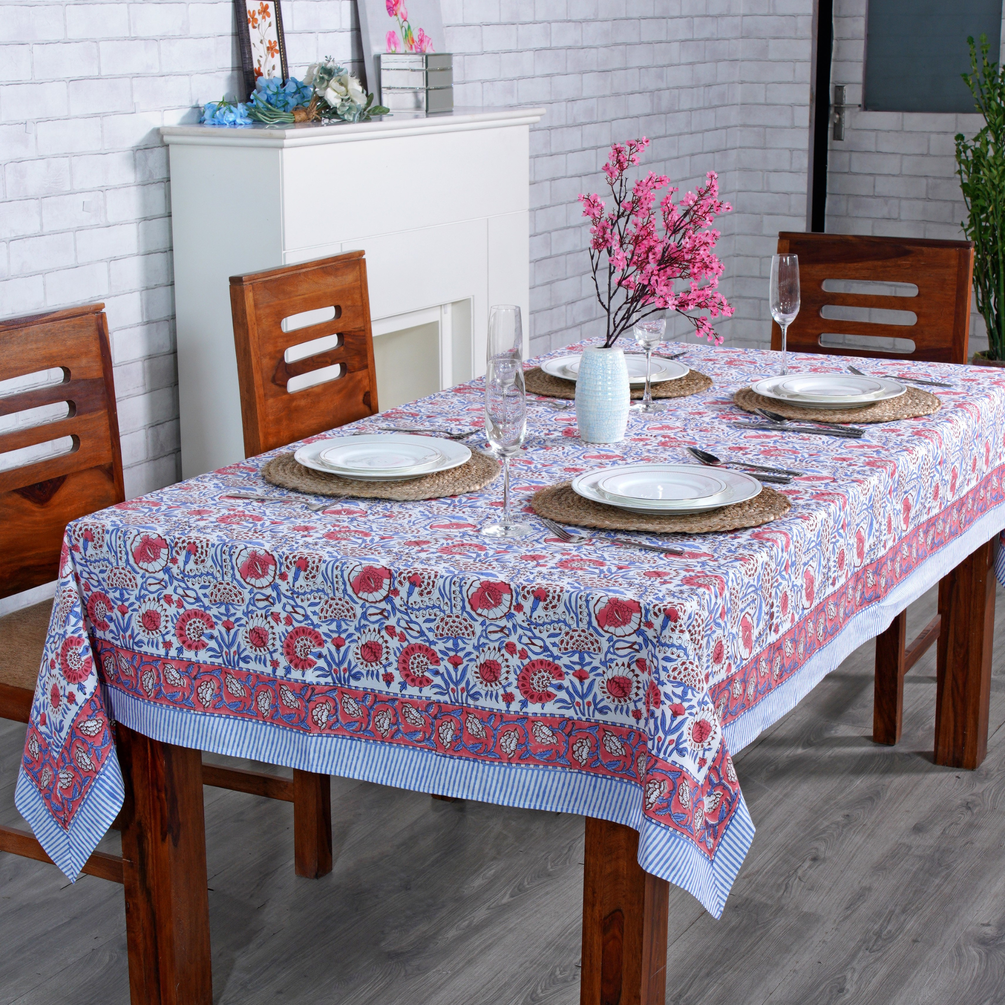 Dining table set with a floral tablecloth in a home setting
