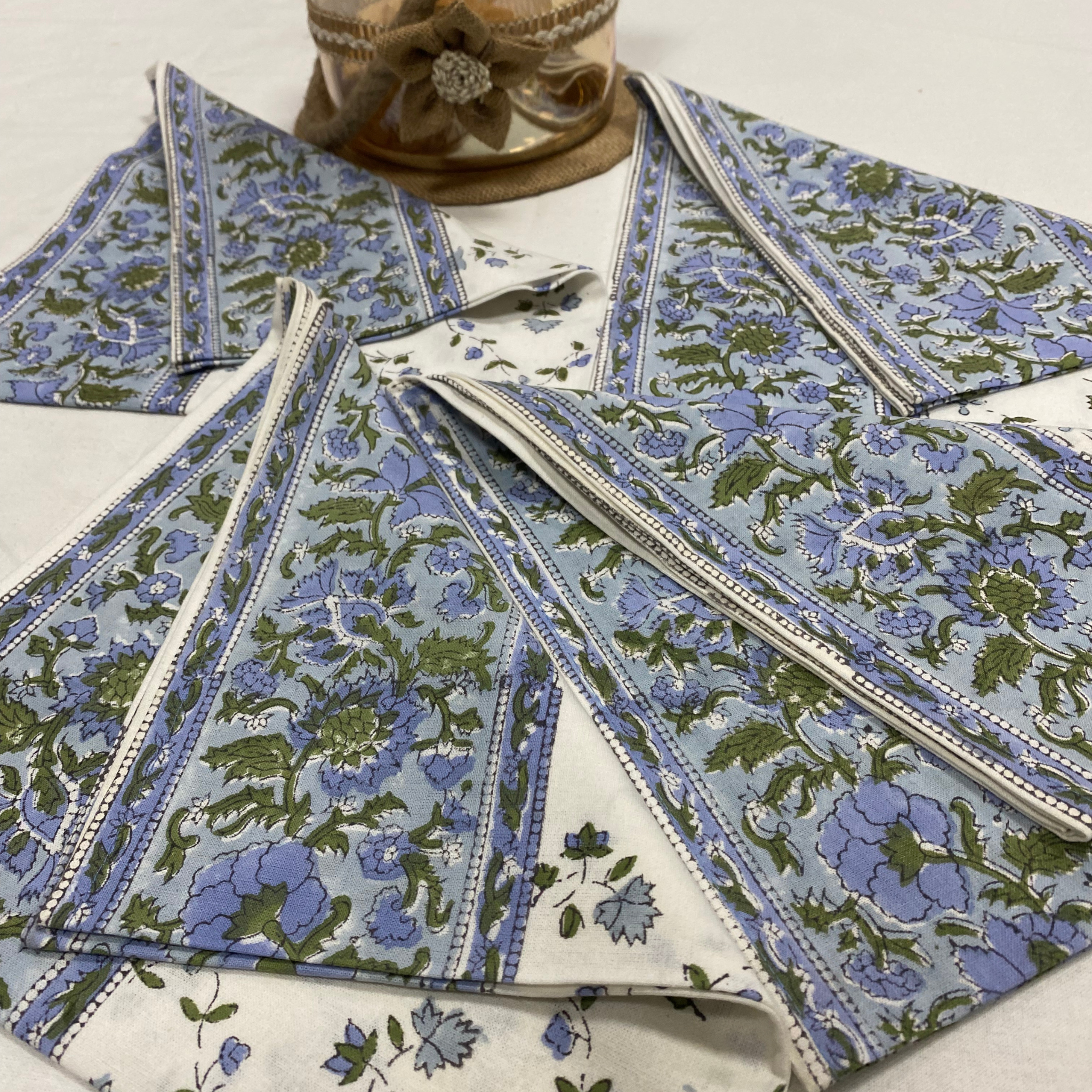 Set of floral-patterned fabric napkins on a white surface