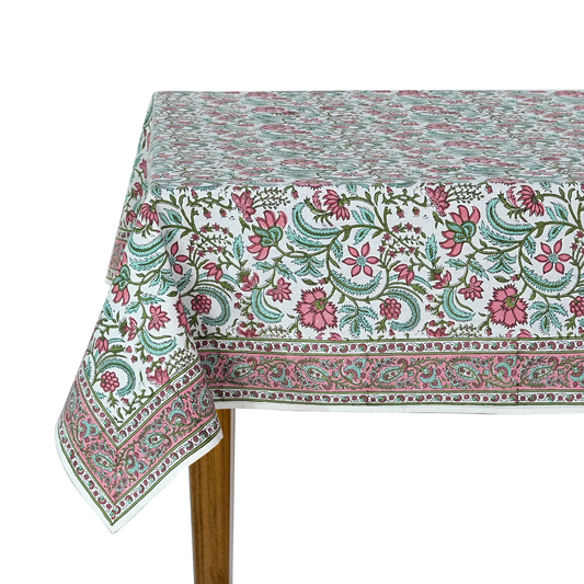 Floral patterned tablecloth on a wooden table with a white background