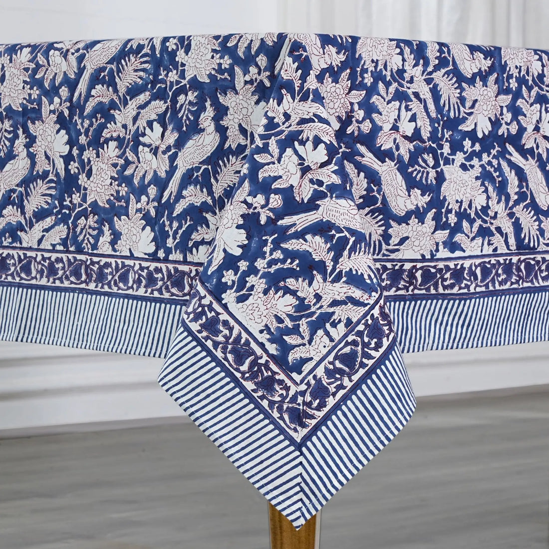Blue and white floral patterned tablecloth on a wooden table.