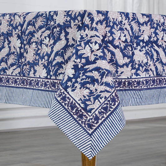 Blue and white floral patterned tablecloth on a wooden table.