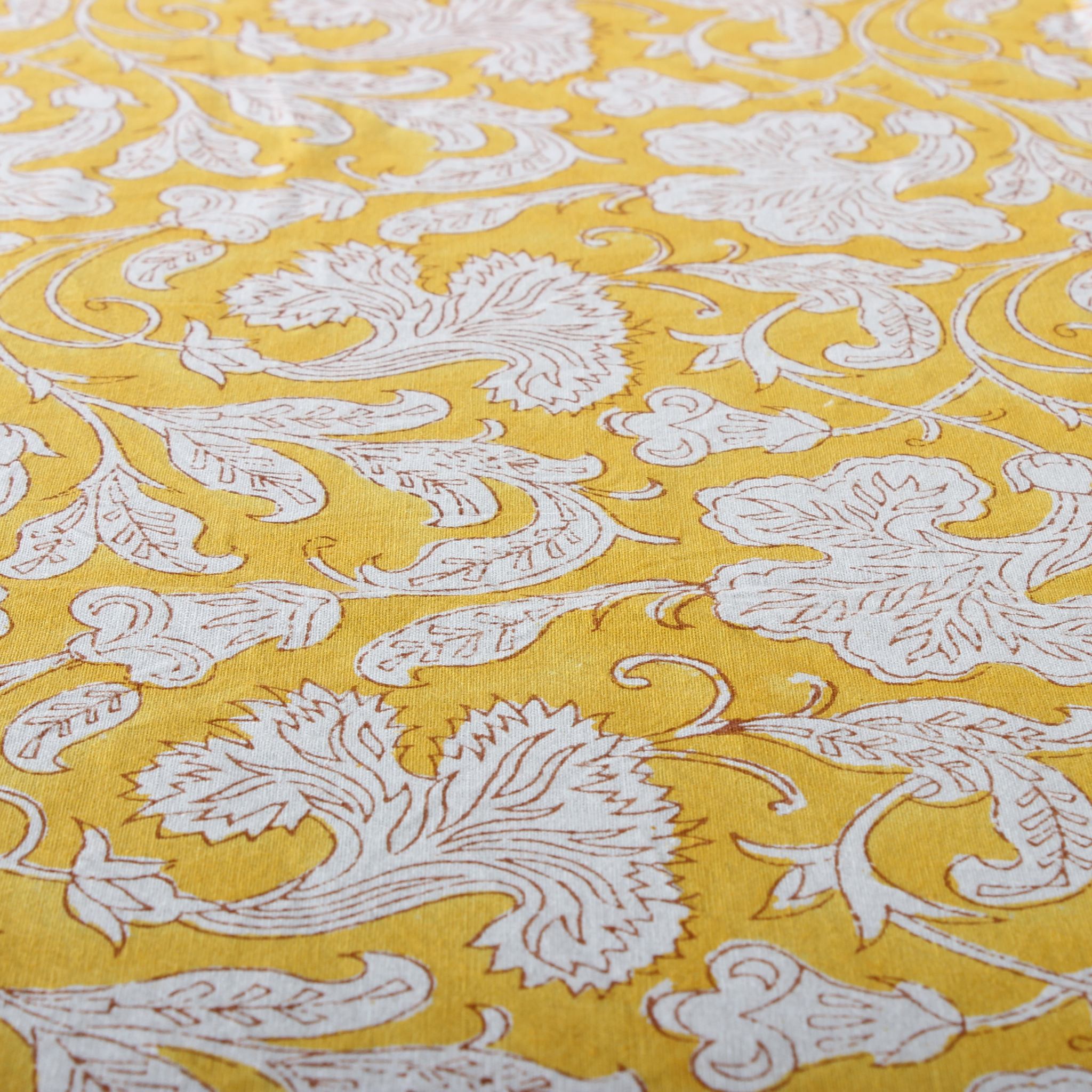 Yellow fabric with white floral patterns