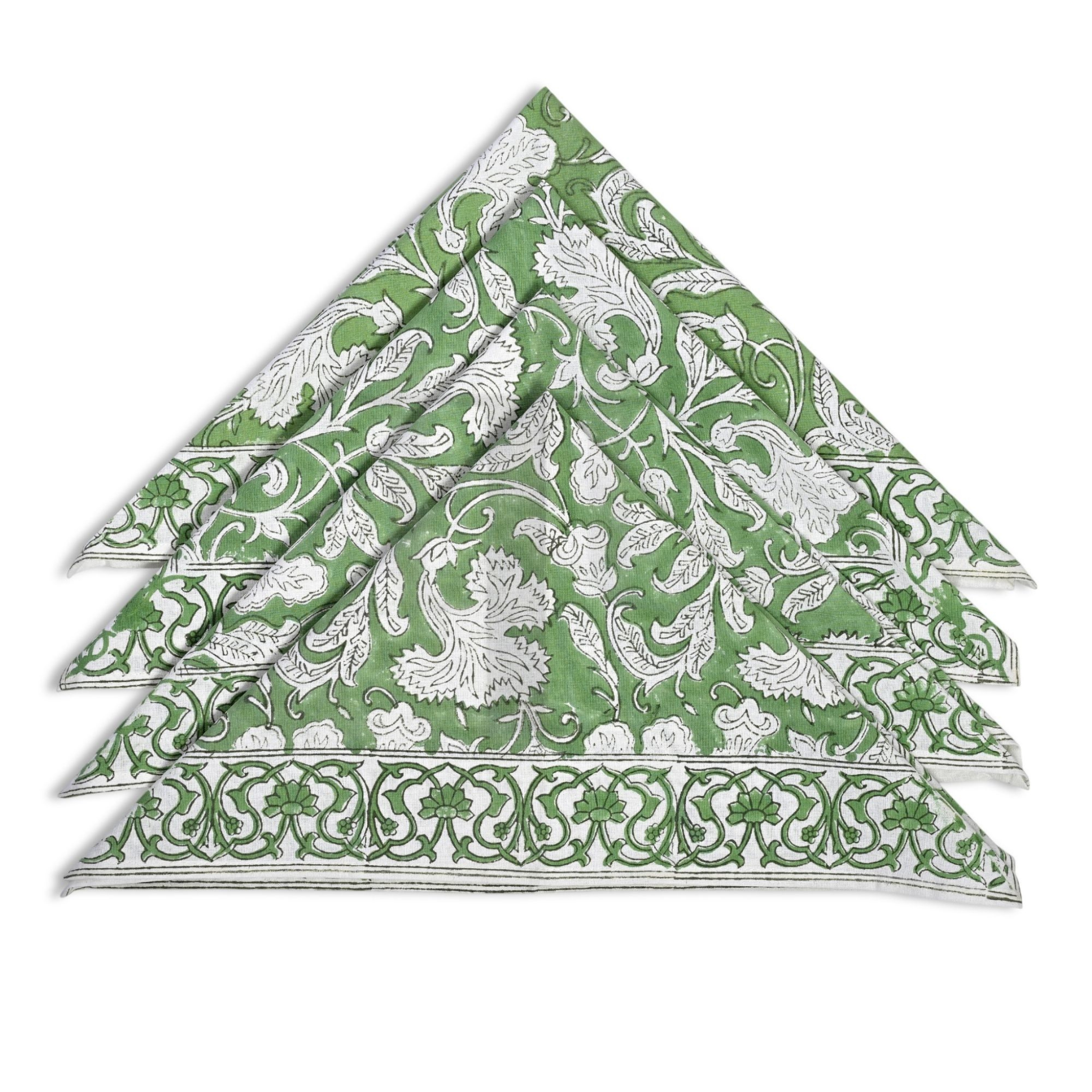 Set of green and white patterned napkins stacked on a white background