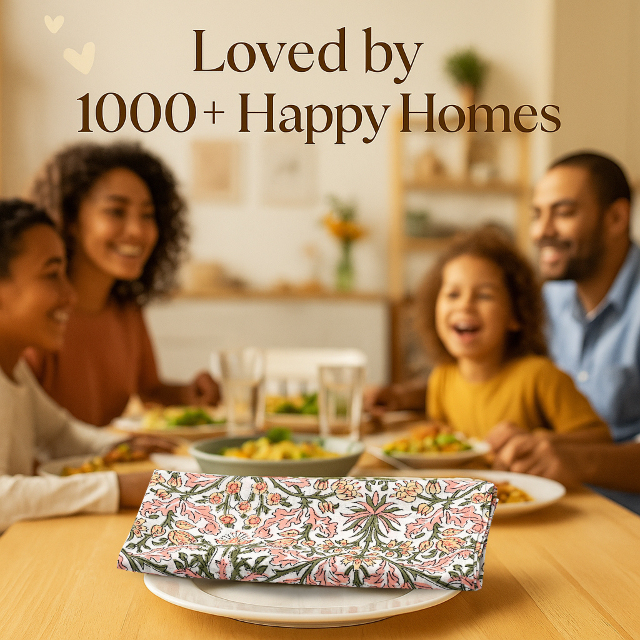 Family sitting around a dinner table with a floral-patterned clutch in the foreground, text 'Loved by 1000+ Happy Homes' above.