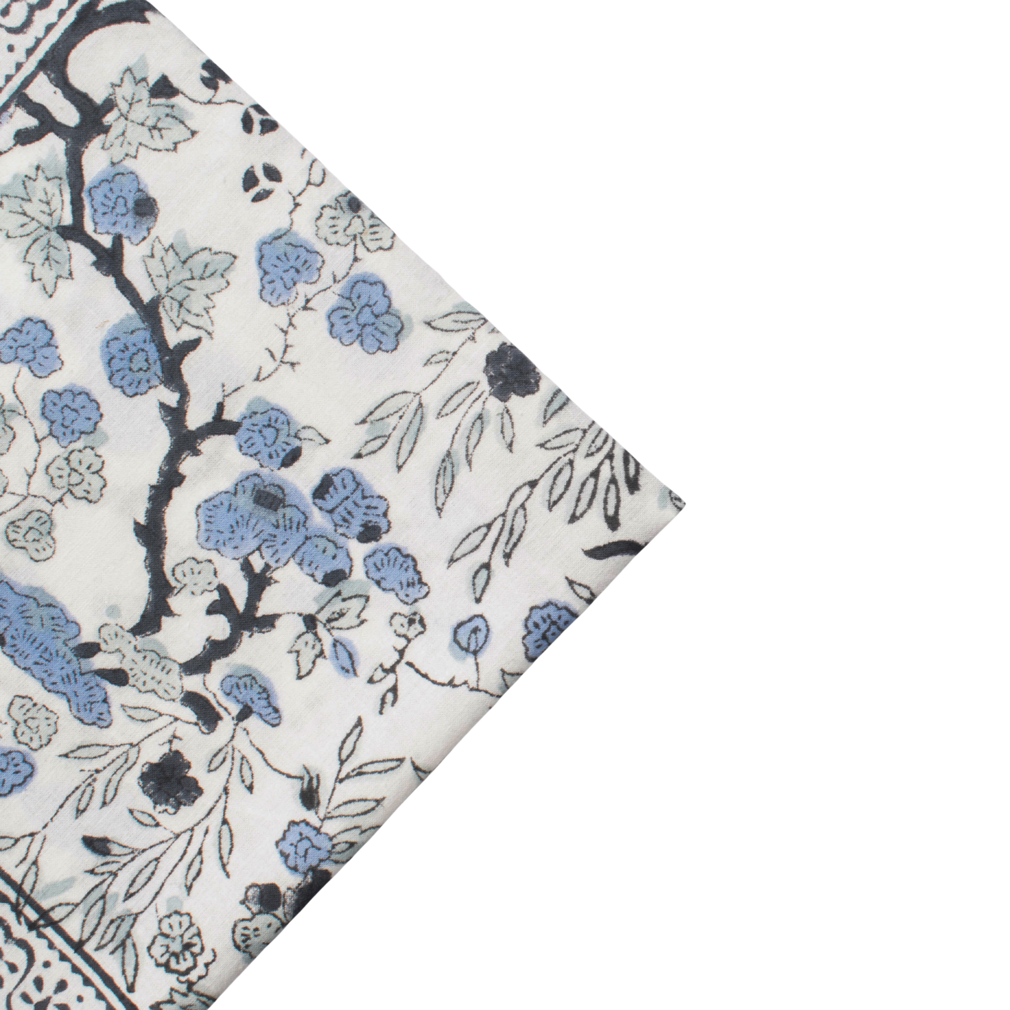 Floral patterned fabric with blue flowers on a white background