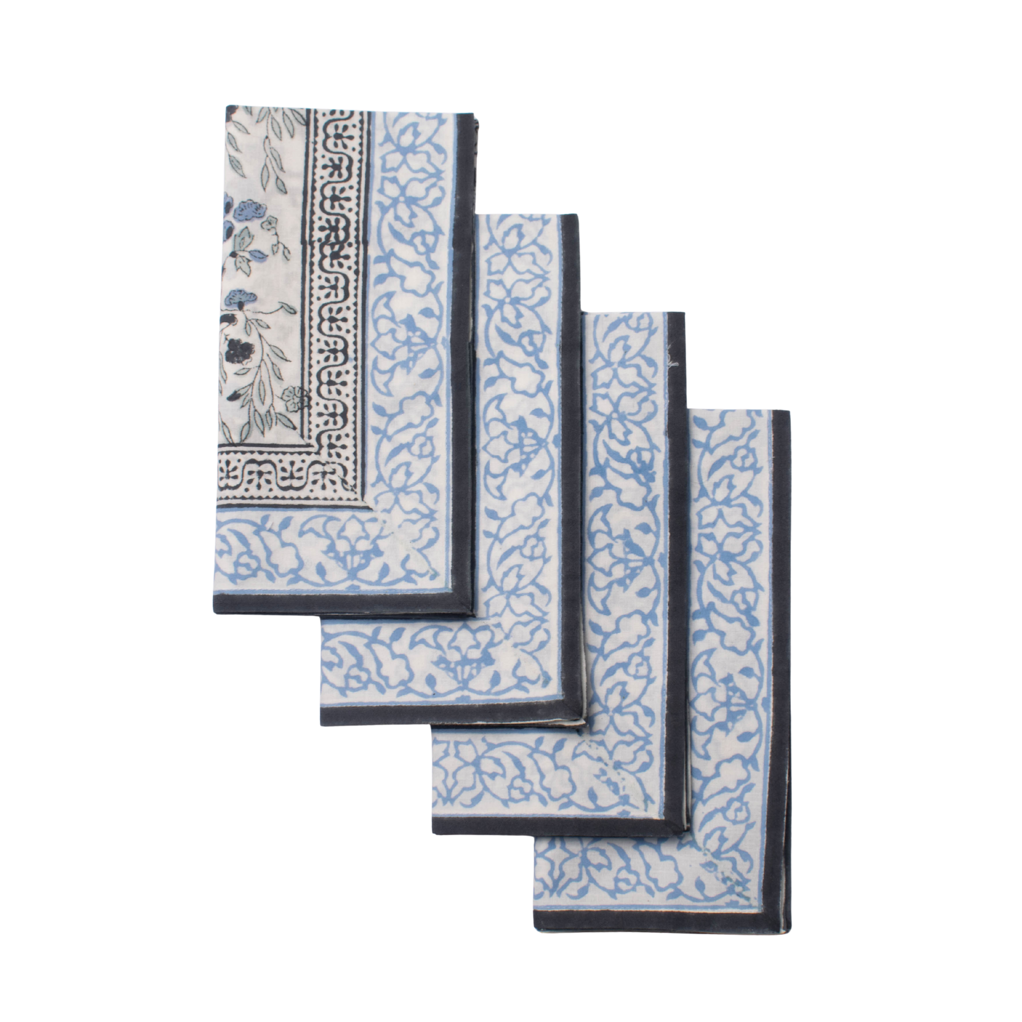 Set of four blue and white patterned napkins on a white background