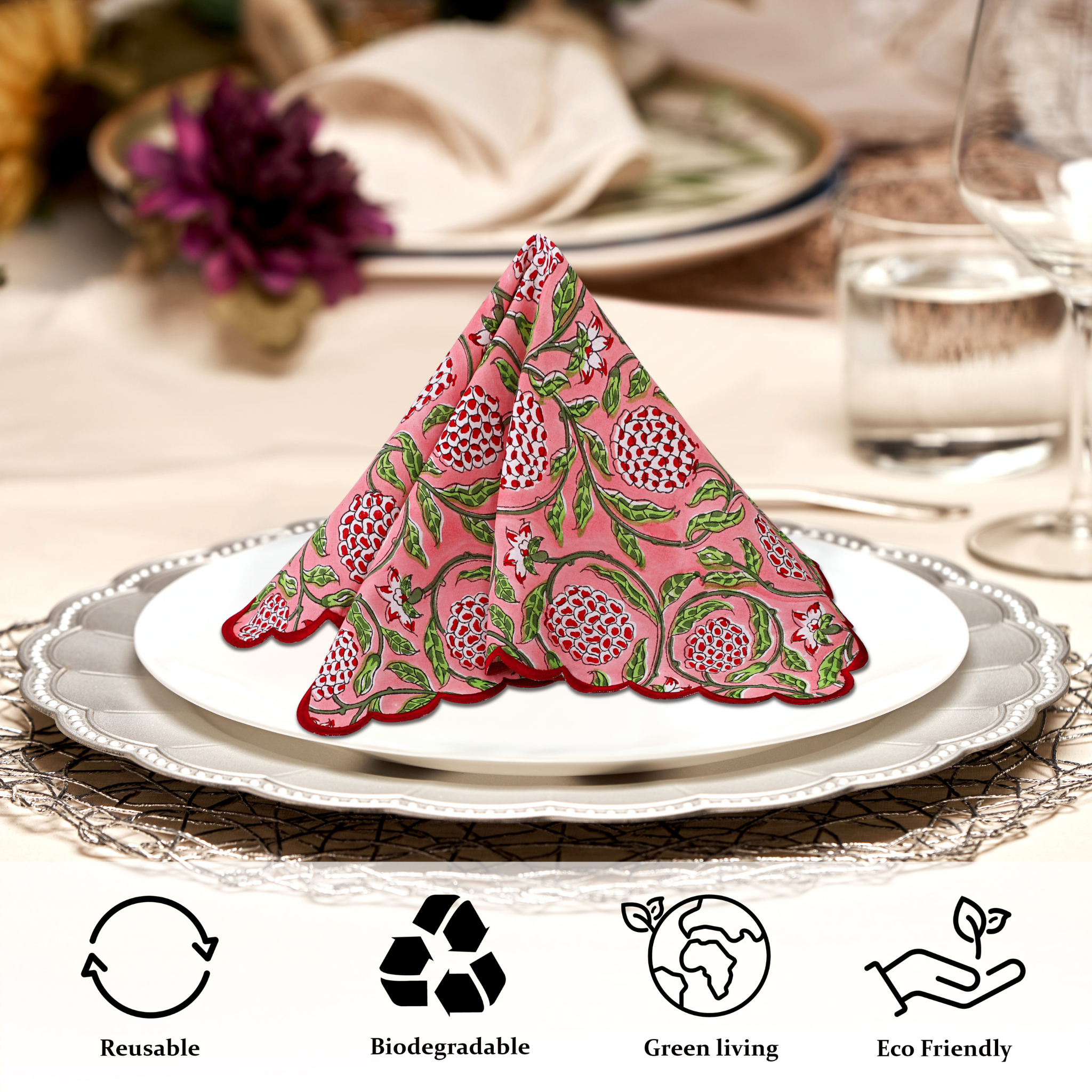 Decorative pink napkin folded into a triangle on a white plate with a table setting in the background.