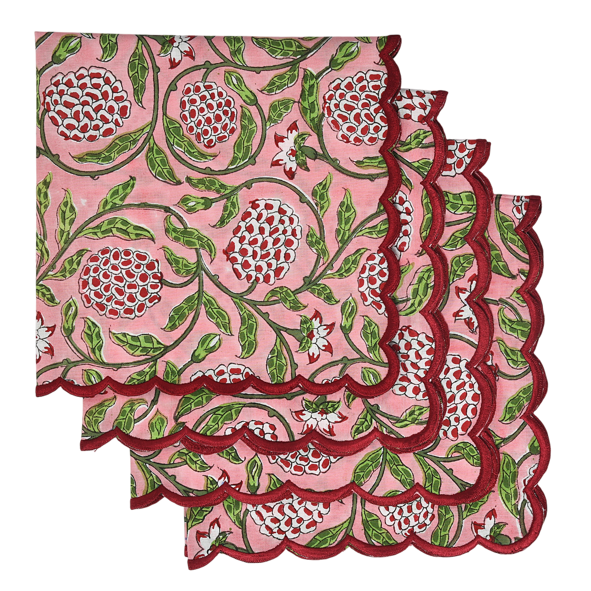 Pink fabric with floral pattern and scalloped edge on a white background