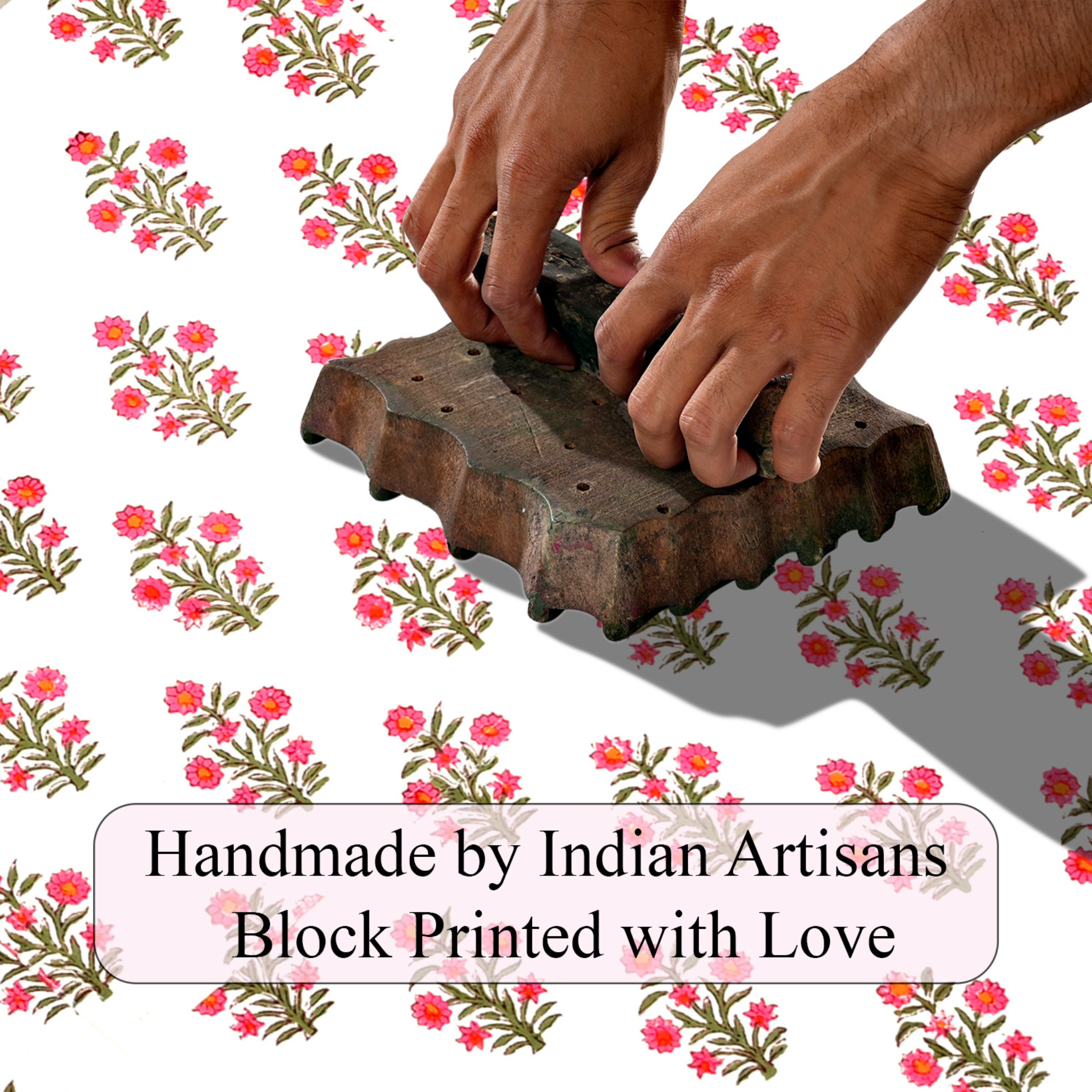 Handmade block printing tool with hands on a floral patterned background
