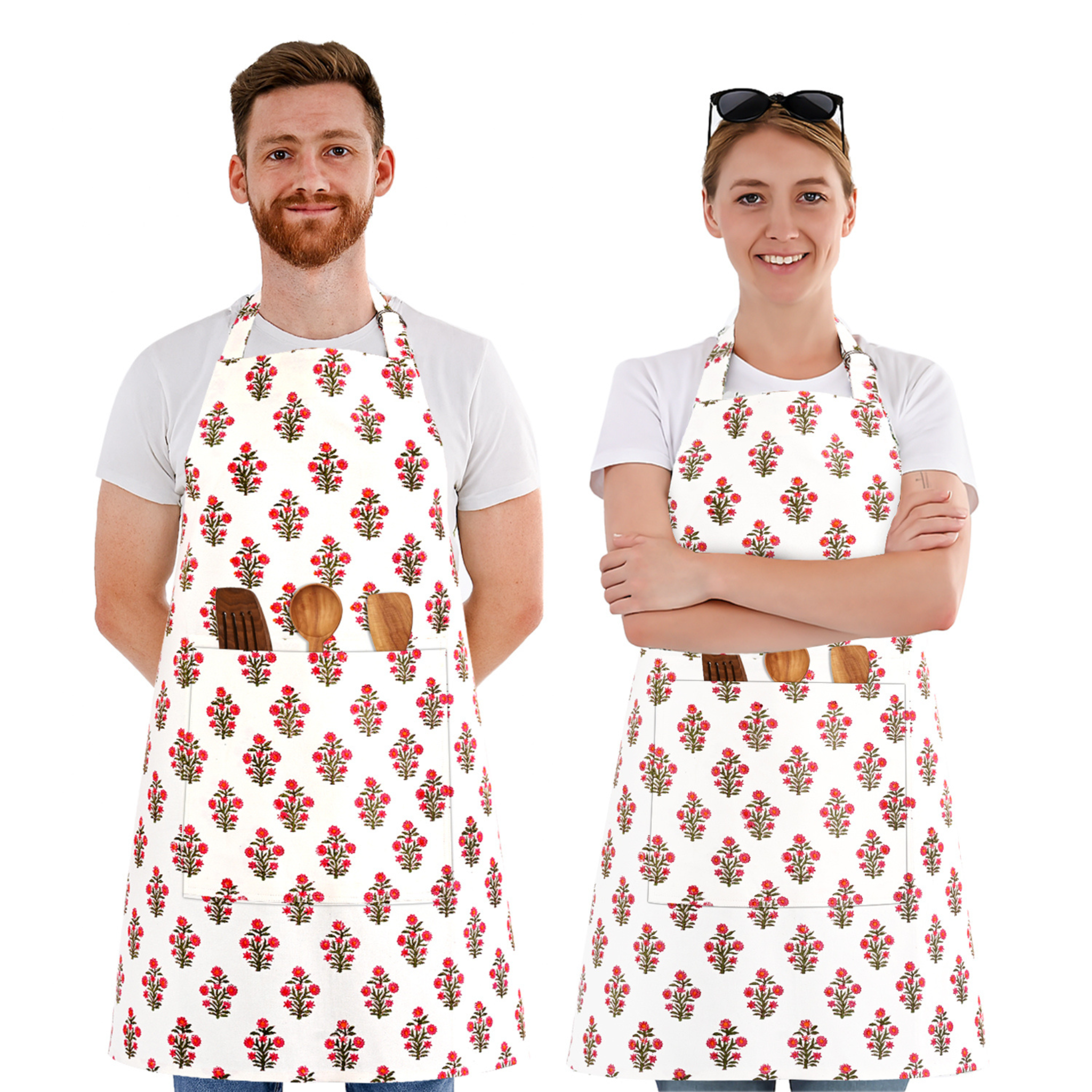 Two people wearing aprons with a floral pattern on a white background