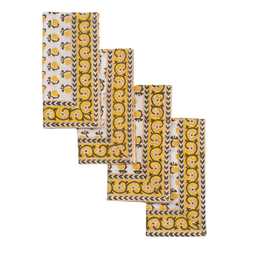 Set of four patterned napkins with yellow and black design on a white background