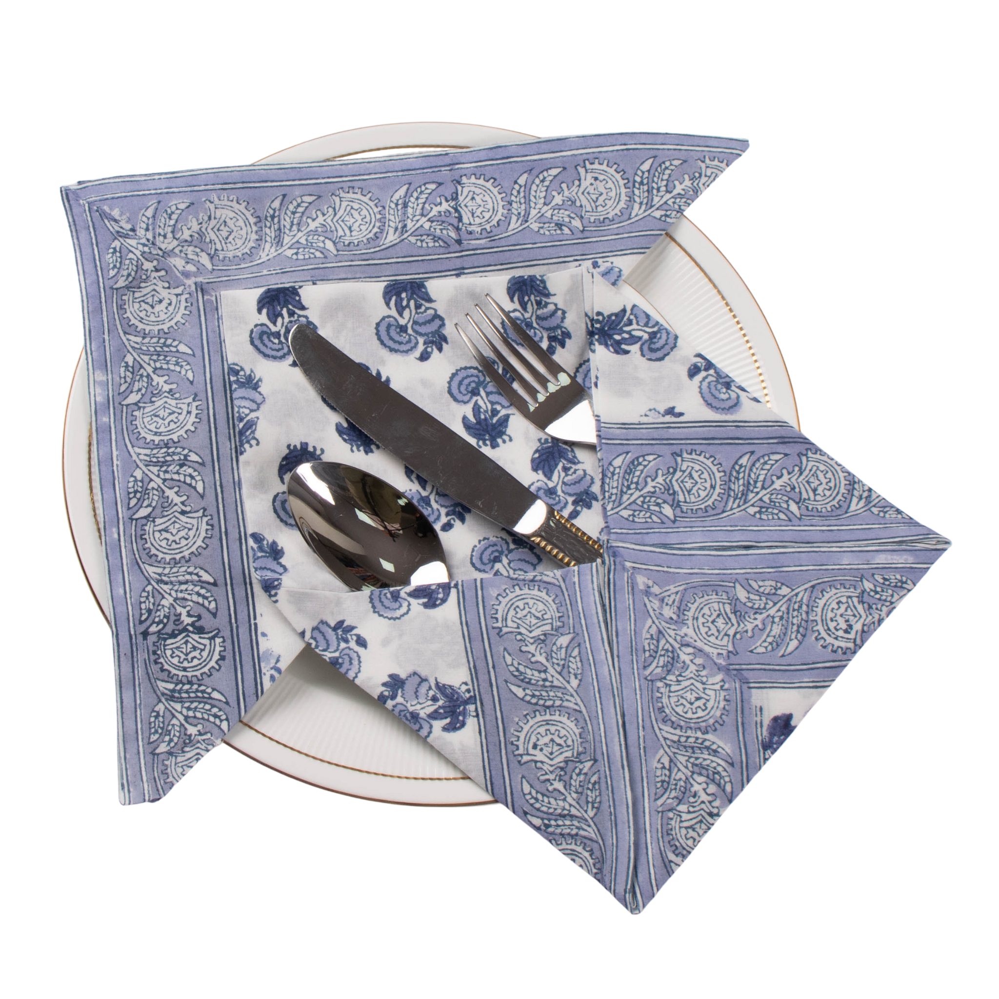 Blue and white patterned napkin with cutlery on a white plate