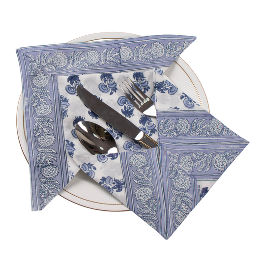 Blue and white patterned napkin with cutlery on a white plate