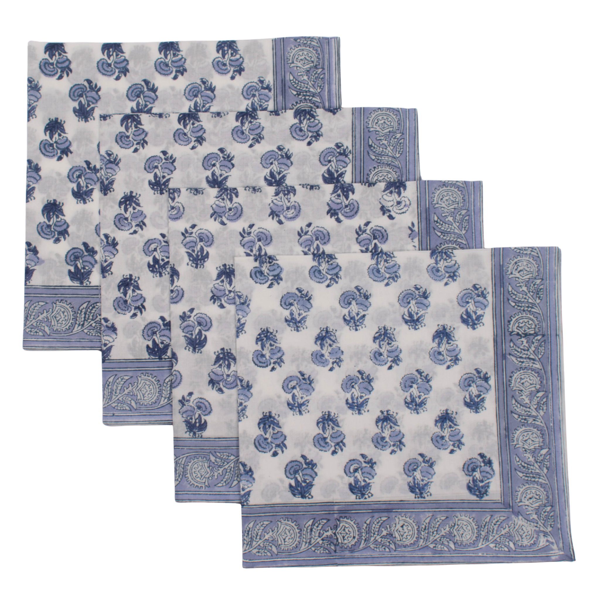 Set of four blue and white patterned placemats on a white background