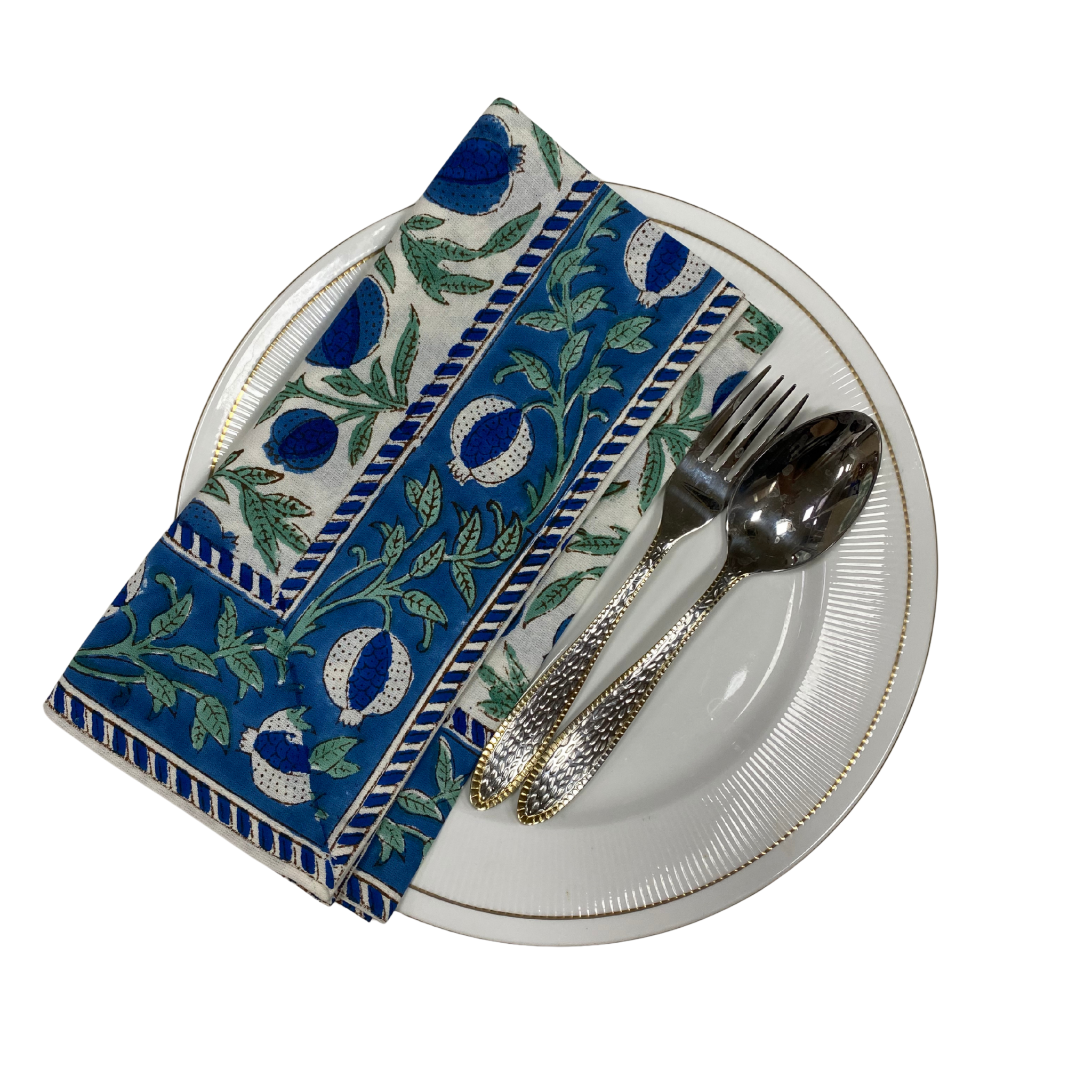 Napkin with blue and green pattern on a white plate with silverware