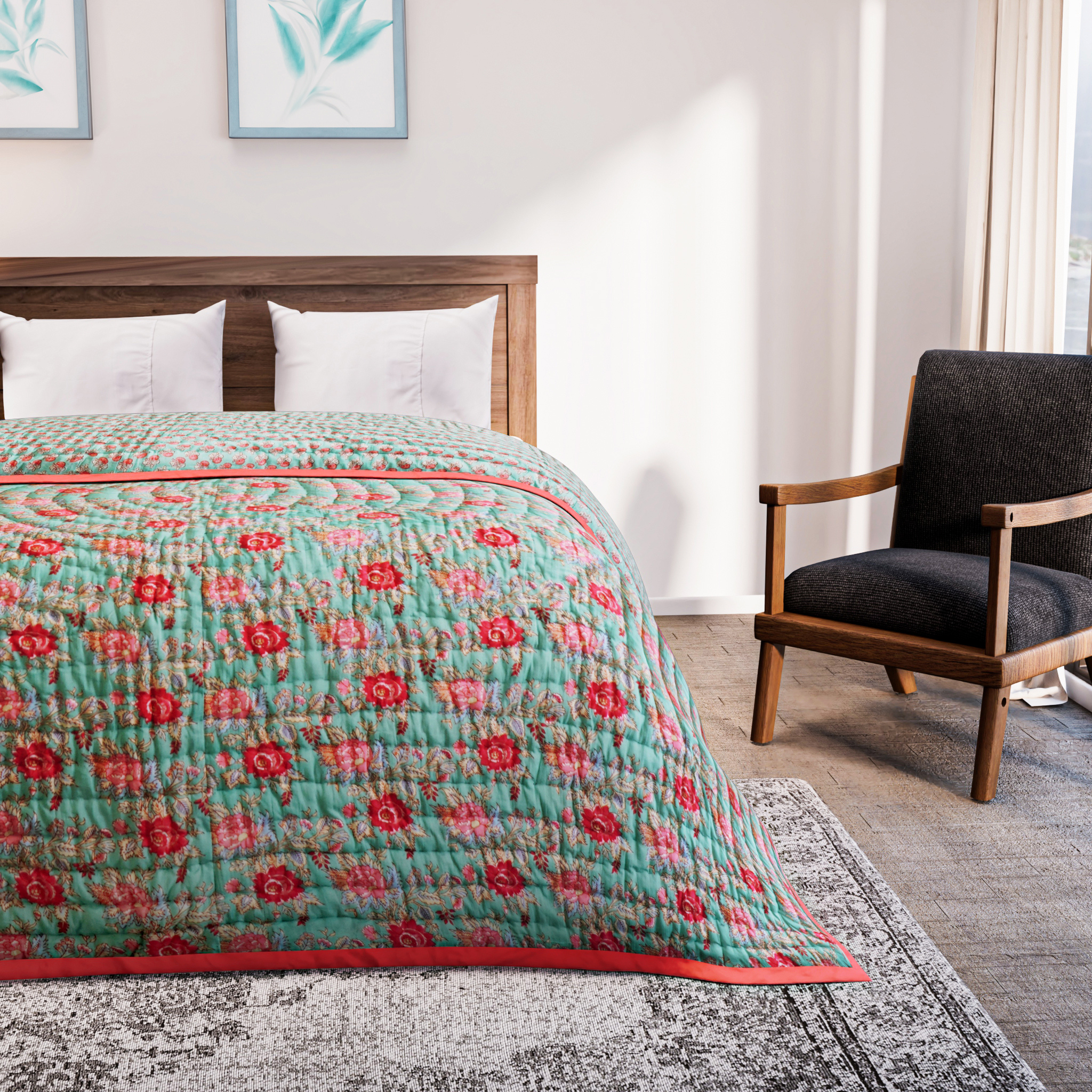 Bed with a floral quilt in a bedroom setting with a chair and artwork on the wall.