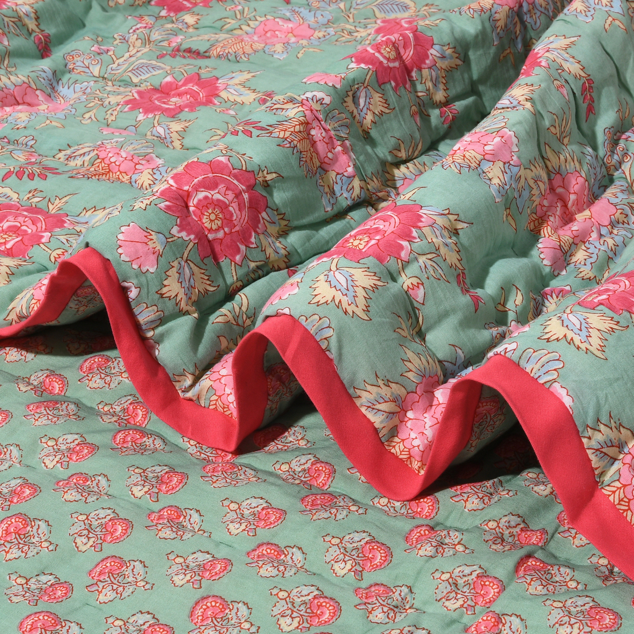 Floral fabric with red trim on a green background